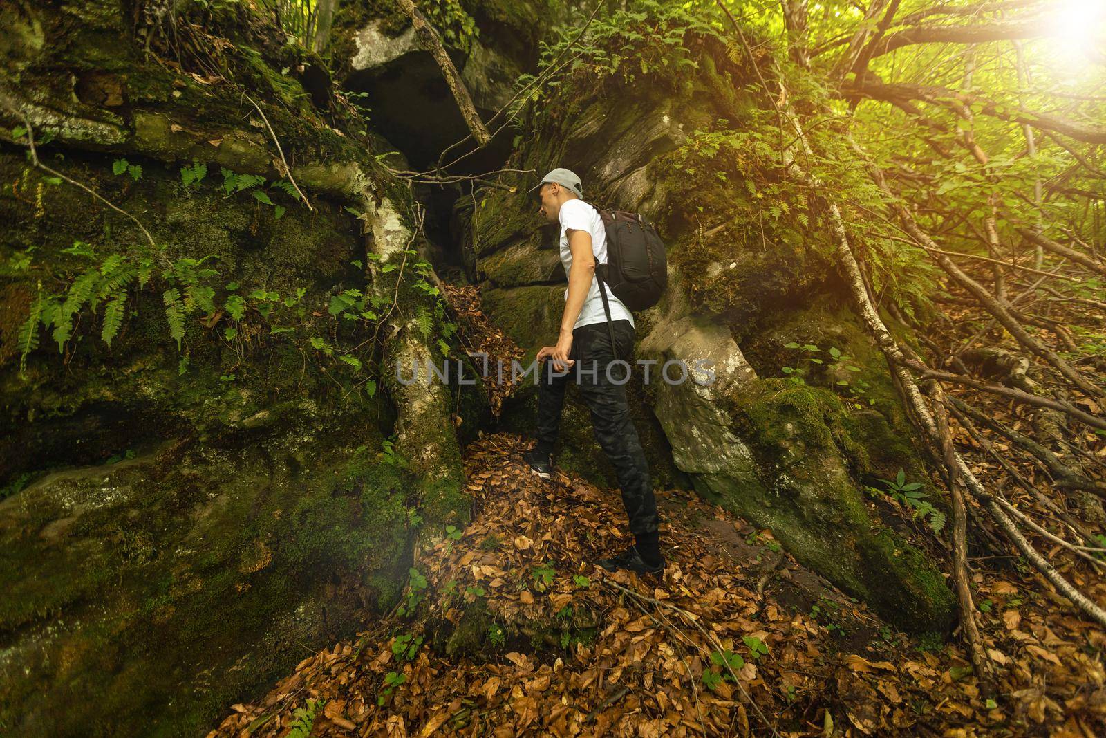 Young man enjoying the view on the top of the mountain. Carpathian mountains, Ukraine.