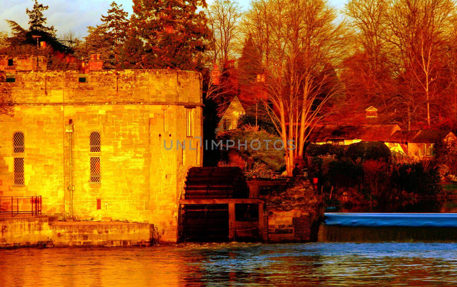 Ancient European medieval architectural building castle in golden autumn light with the blue sky background during autumn