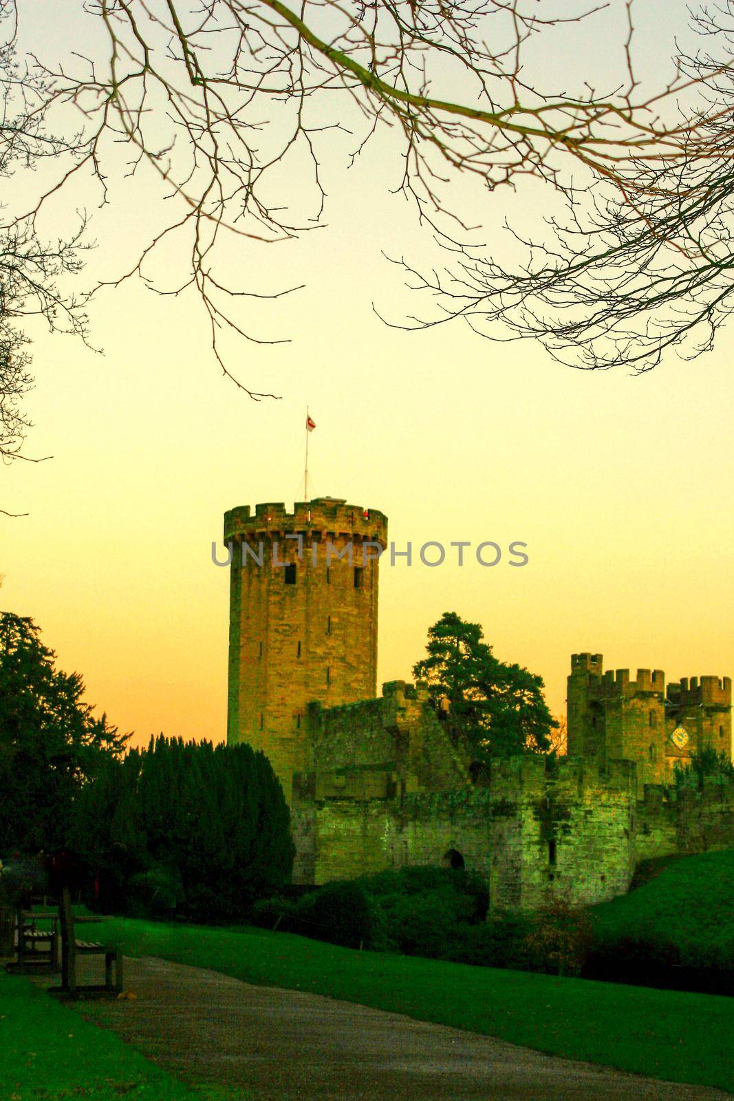 Ancient European medieval architectural building castle in golden autumn light with the blue sky background during autumn