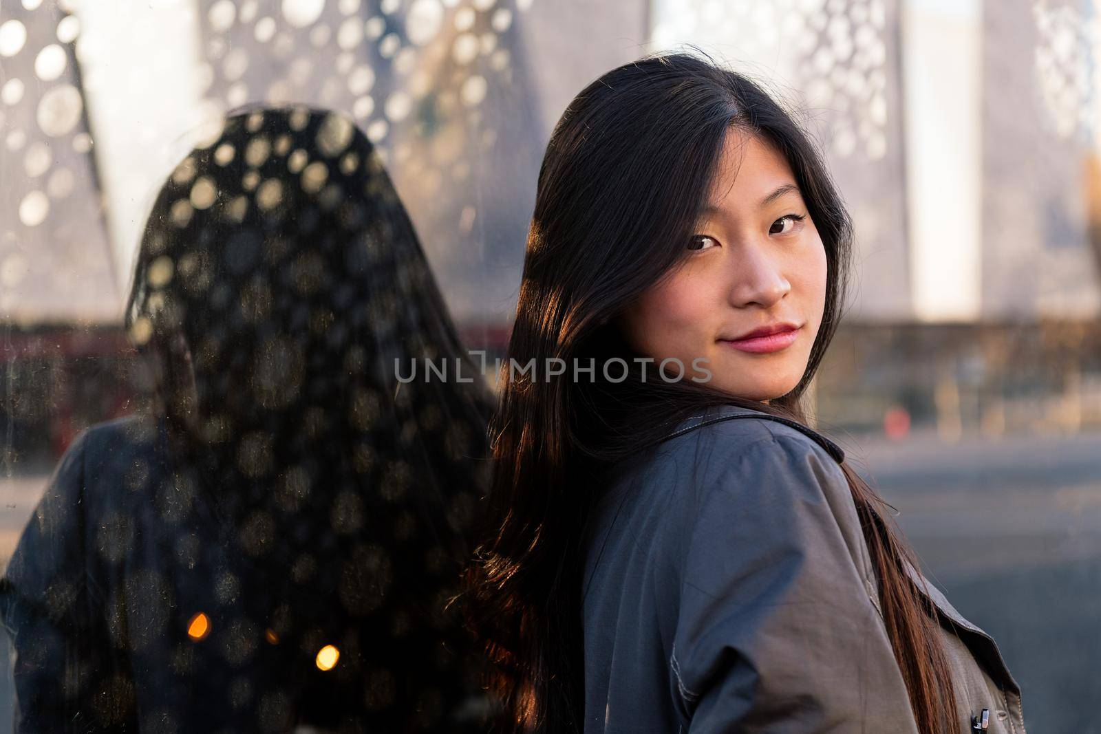 portrait of a young beautiful asian woman with a happy and cool smile on face, copy space for text