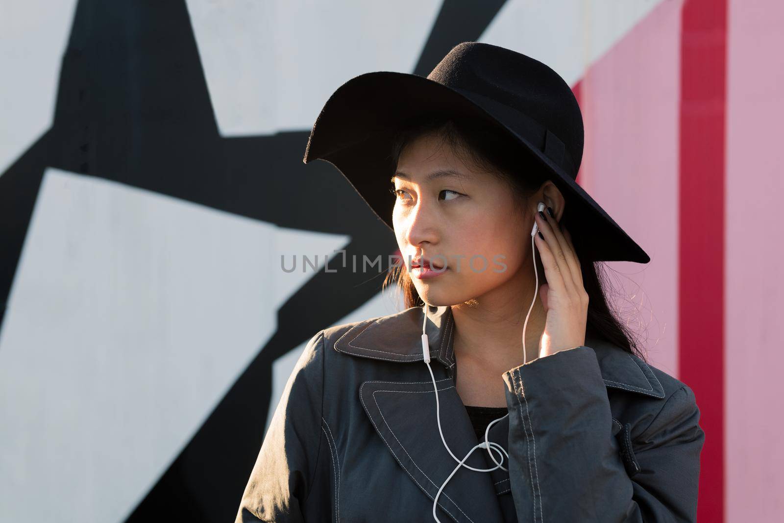 young beautiful classy asian woman with earphones listening music, concept of technology and fashion lifestyle