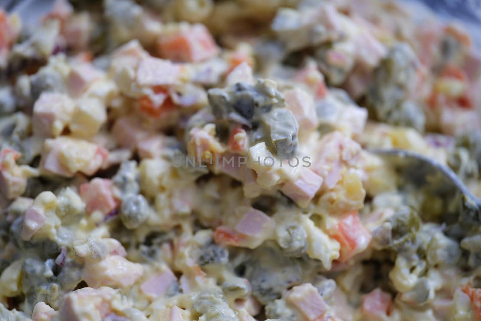 Olivier salad and food ingredients green peas cucumber potatoes sausage and mayonnaise. Delicious fresh traditional salad olivier concept