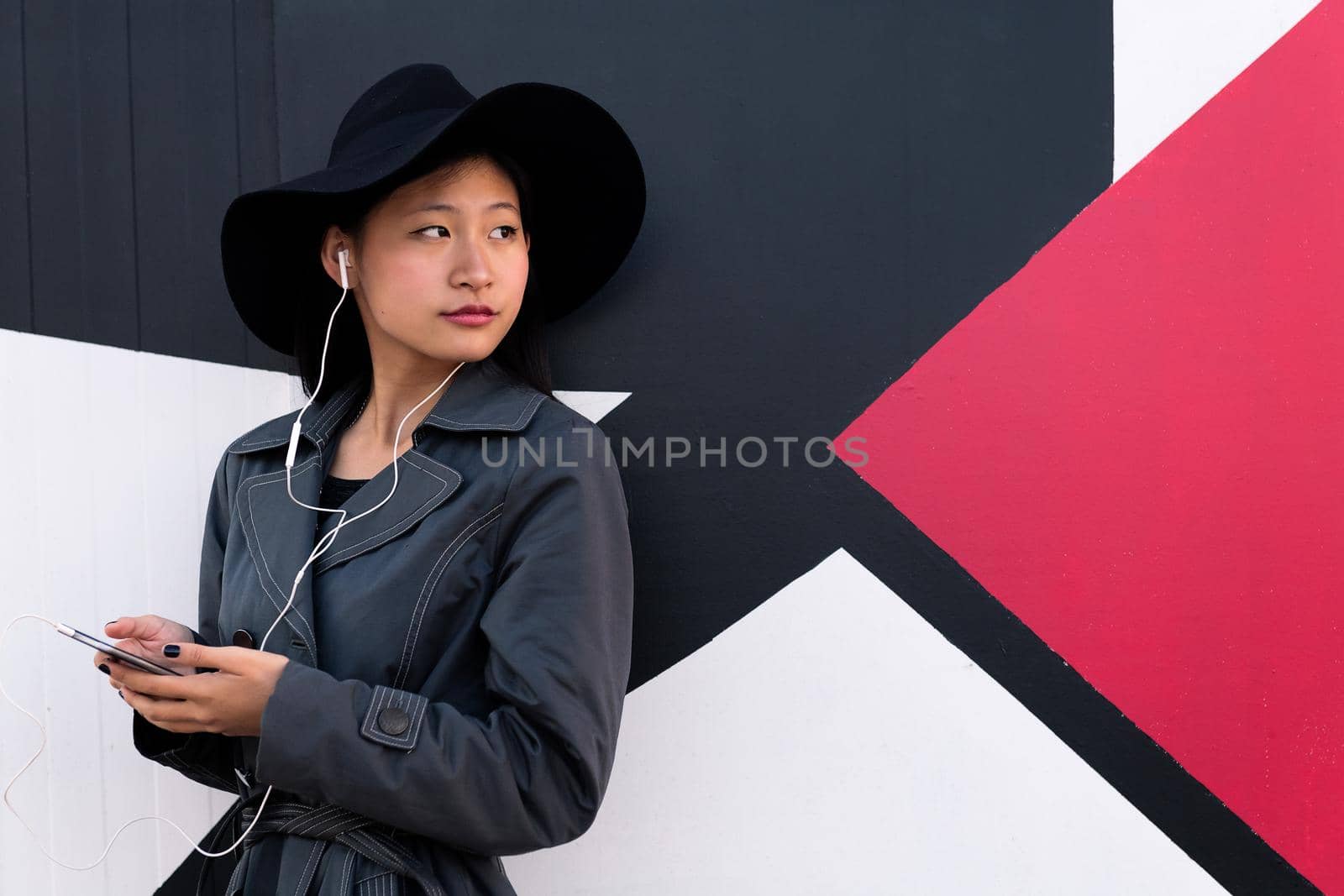 chinese woman listening music with earphones by raulmelldo