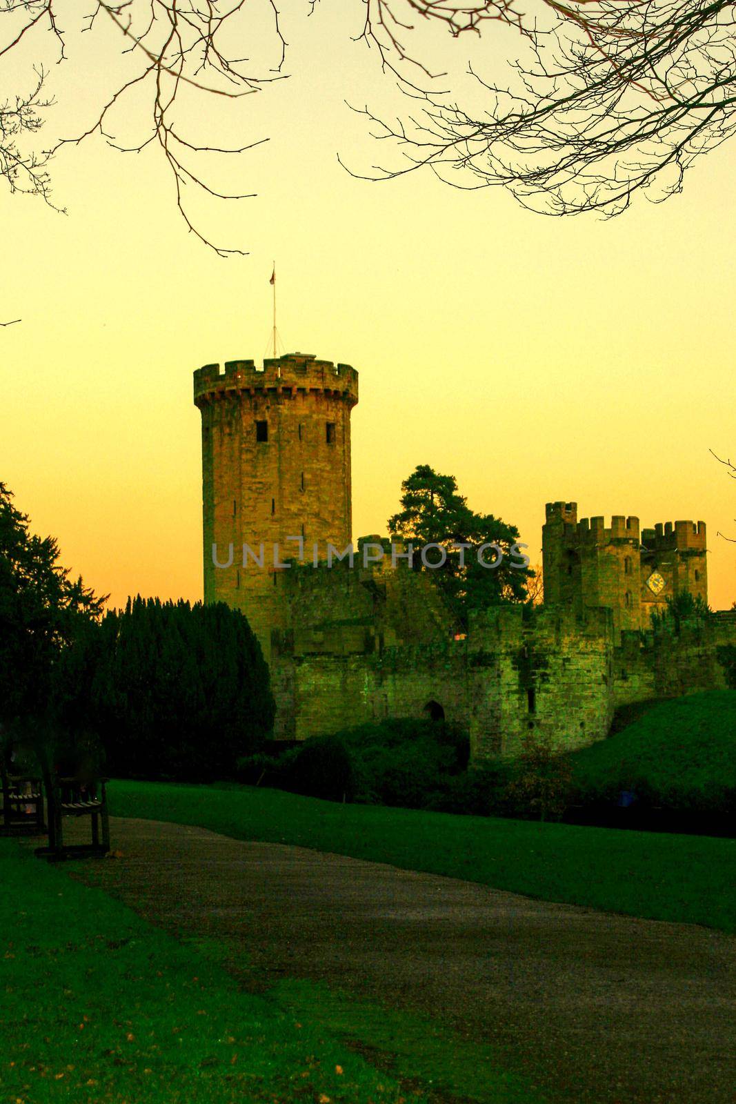 Ancient European medieval architectural building castle in golden autumn light with the blue sky background during autumn