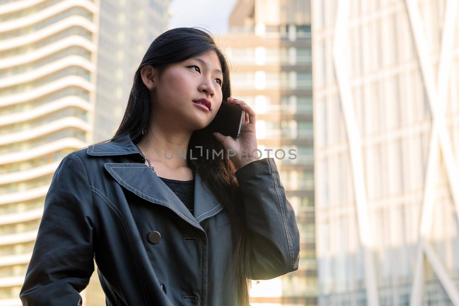 young asian woman talking by phone in the city by raulmelldo