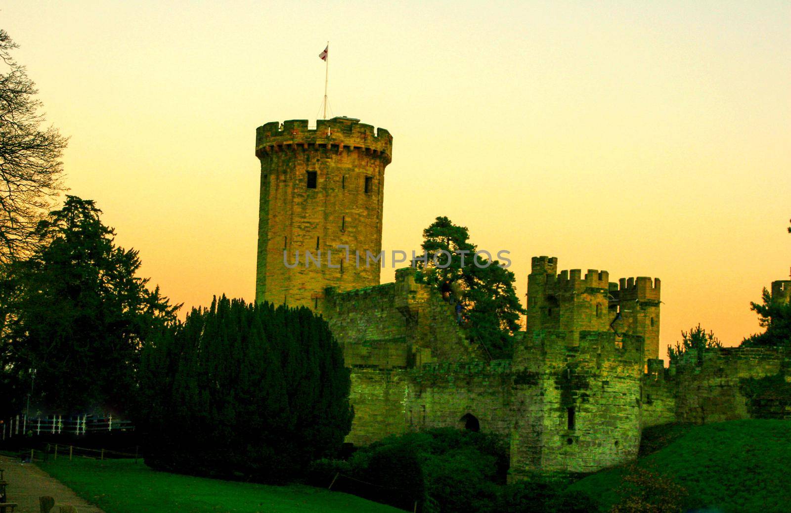 Ancient European medieval architectural building castle in golden autumn light with the blue sky background during autumn