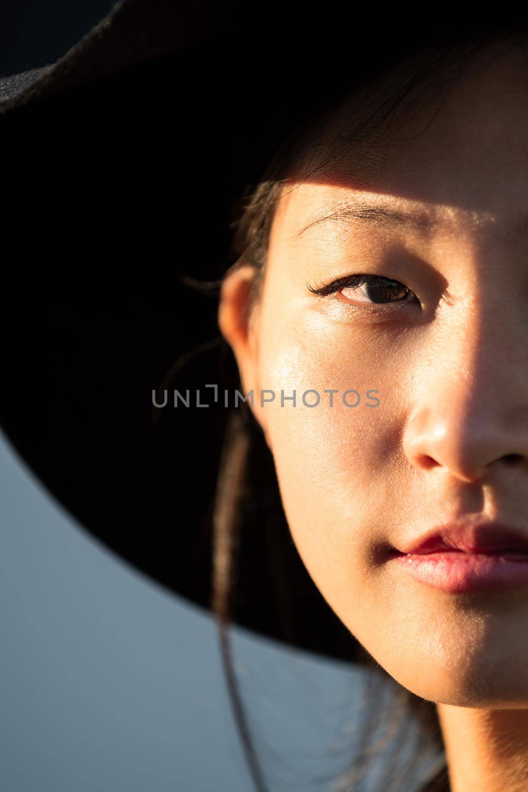 half face portrait of a beautiful young oriental woman, fashion and lifestyle concept, copy space for text