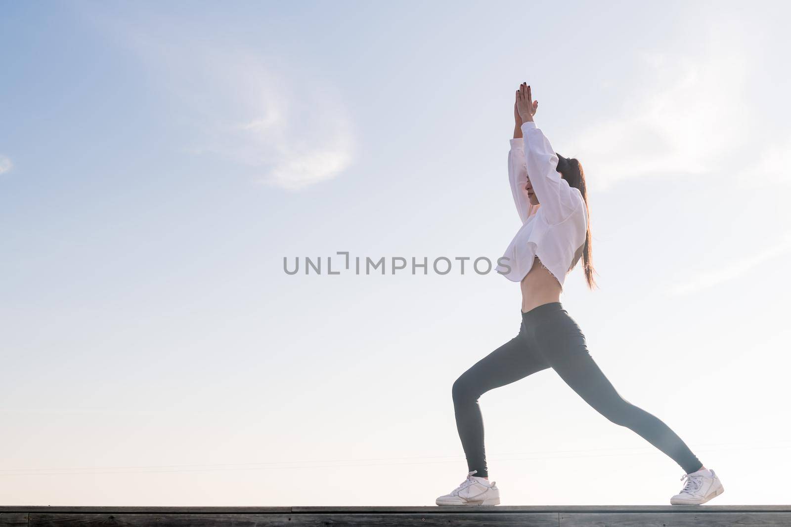 beautiful young asian woman practicing yoga in the morning, concept of relaxation and mental health, copy space for text