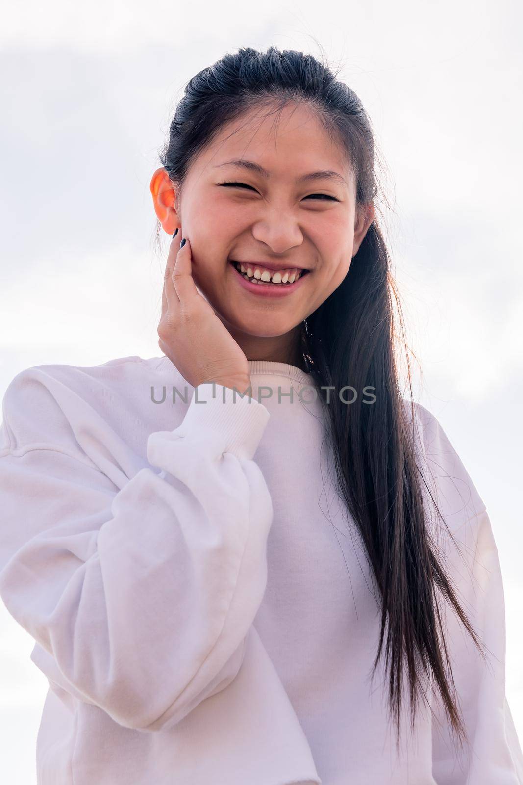 young asian woman dressed in white laughing happy and funny, concept of youth and healthy lifestyle