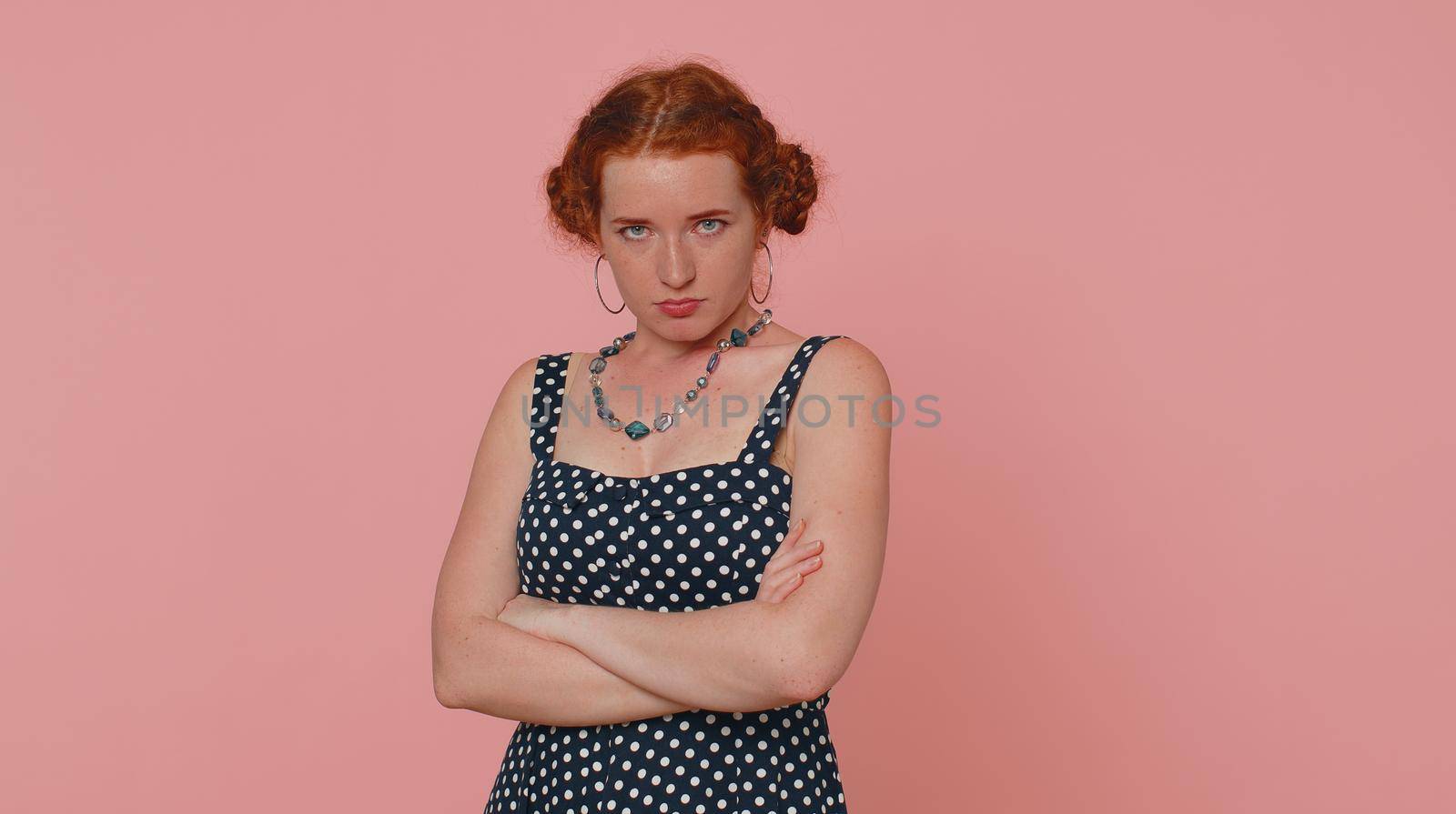 Woman feeling hopelessness and loneliness, nervous breakdown, loses becoming surprised by lottery results, bad fortune, loss, unlucky news. Ginger girl with freckles isolated on pink studio background