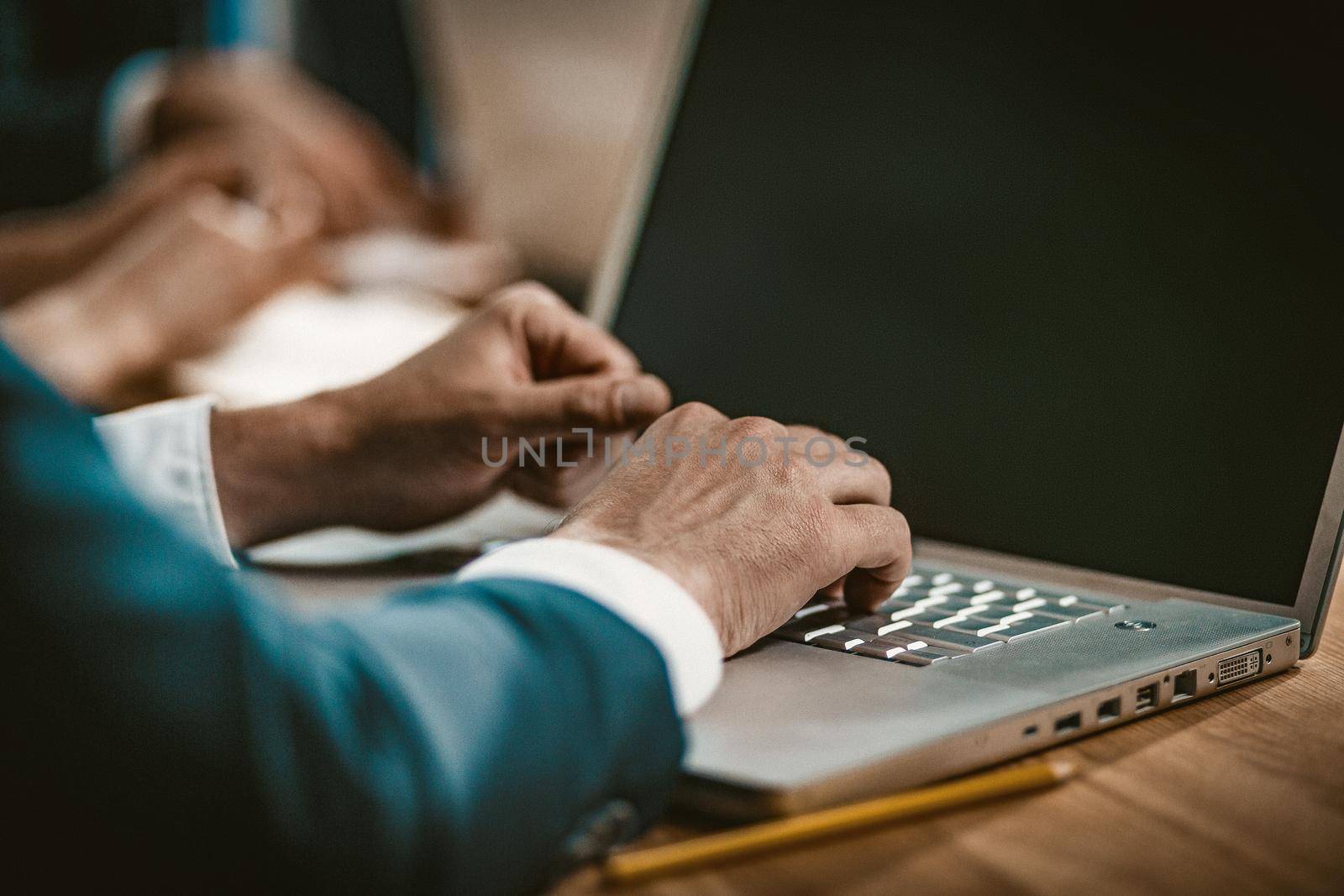 Businessman Uses Wireless Technology In Notebook by LipikStockMedia