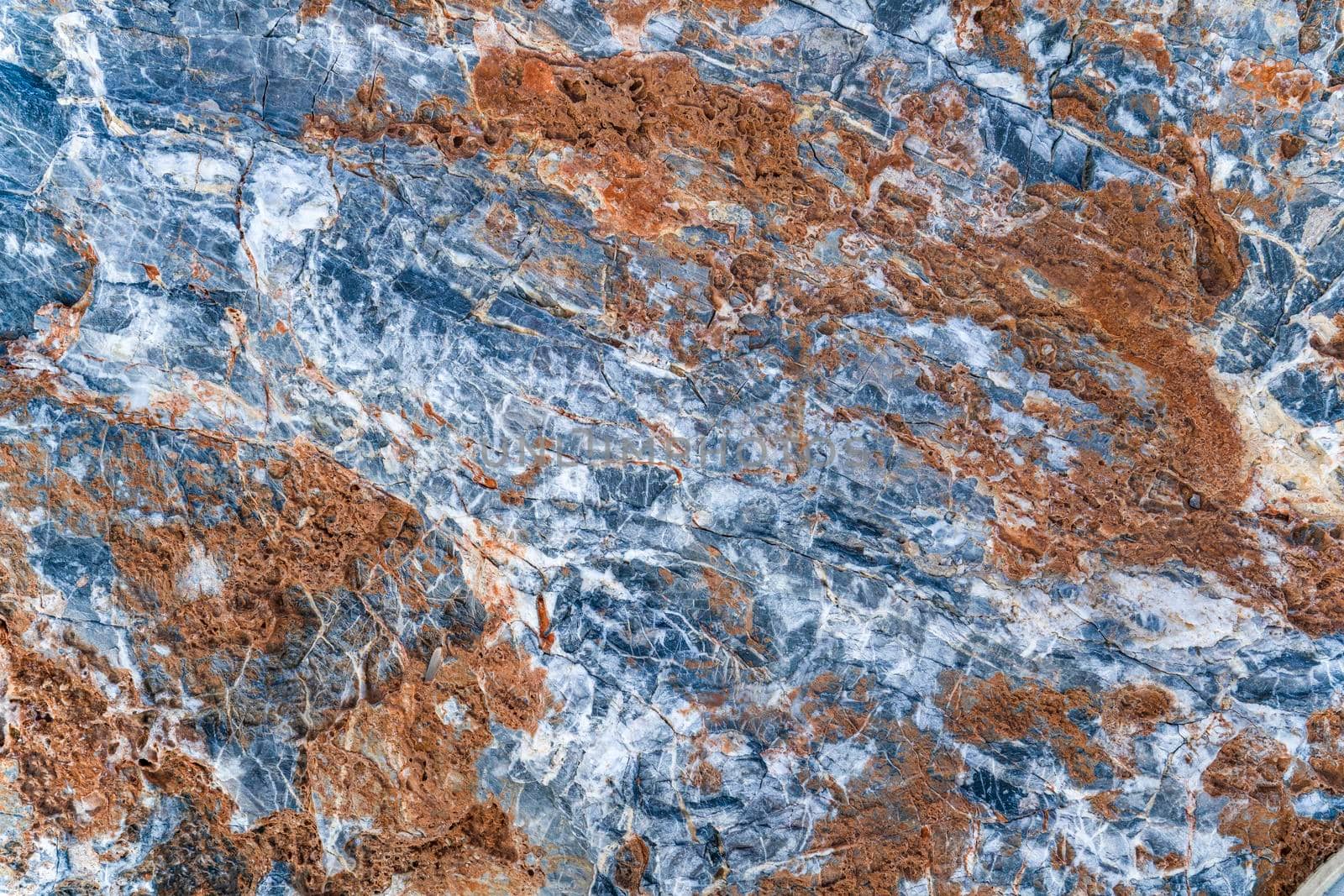 Texture of stone slab with gray-orange pattern with white streaks