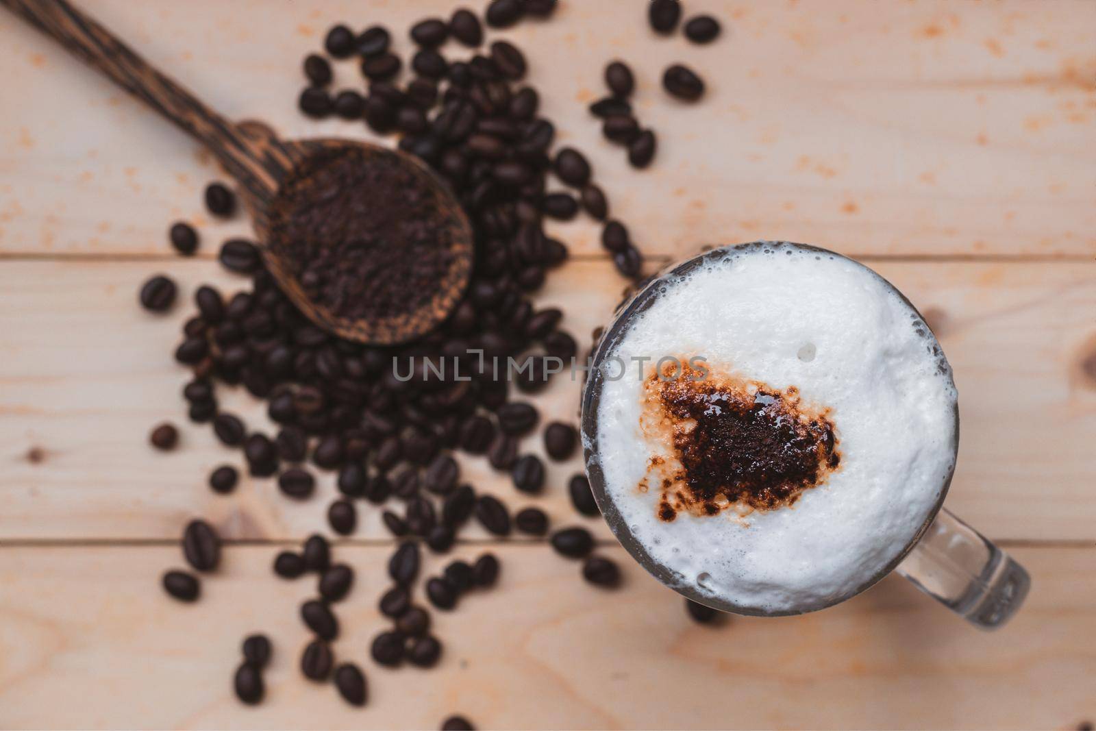 Top view selective focus of iced coffee froth in coffee mug cup. by wattanaphob