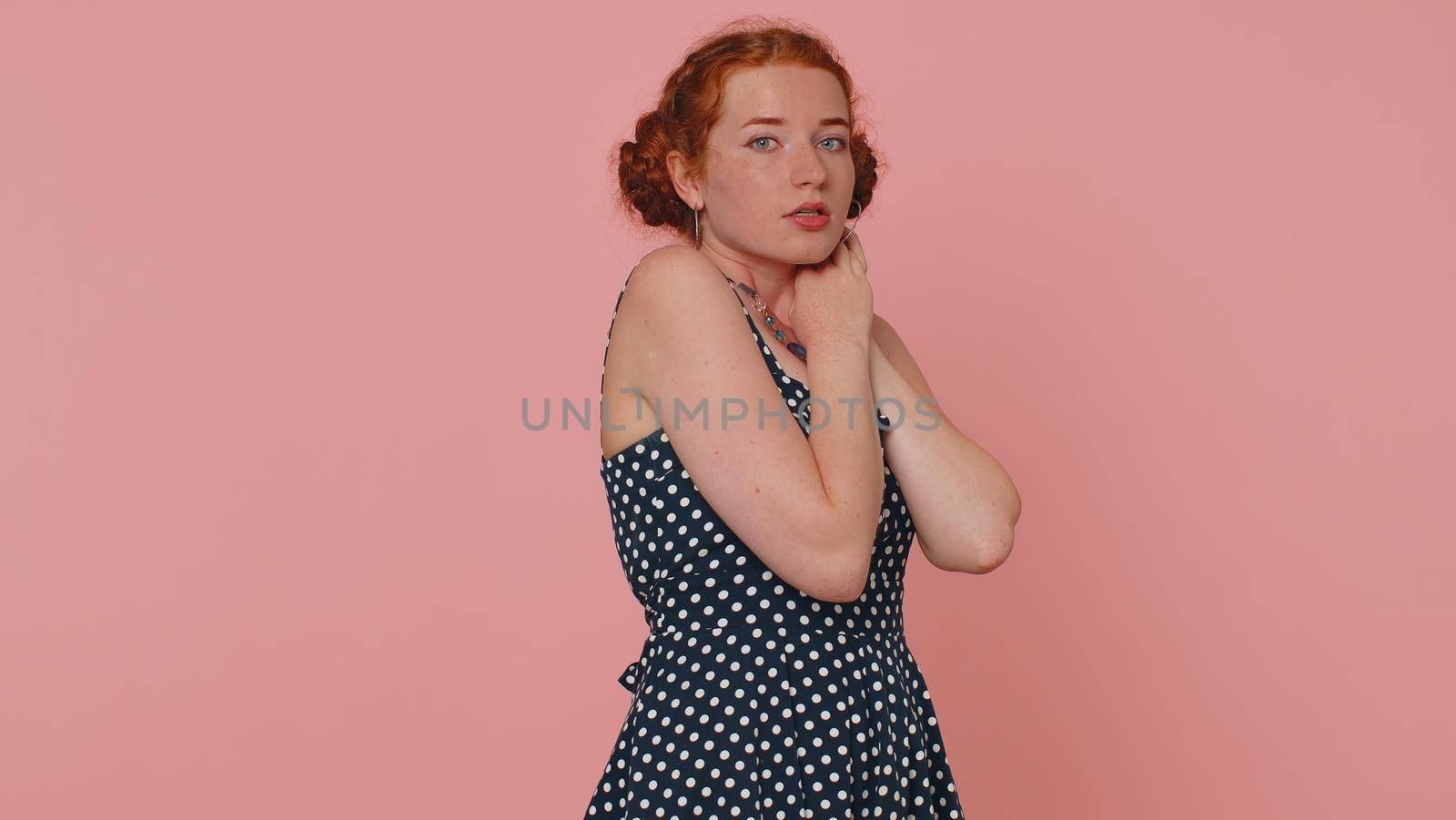 Scared fearful young redhead woman terrified about danger problems, suffering phobia, anxiety disorder, expresses fear, waving no, insecure, stress, panic. Ginger girl with freckles on pink background