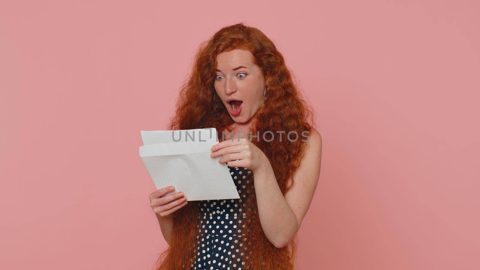 Woman Open Envelope Take Out Letter Reads It Feel Happy. Career Growth Advance Promotion Bank Loan Approve Monetary Award Long-Awaited Invitation Great News. Girl Isolated On Pink Studio Background