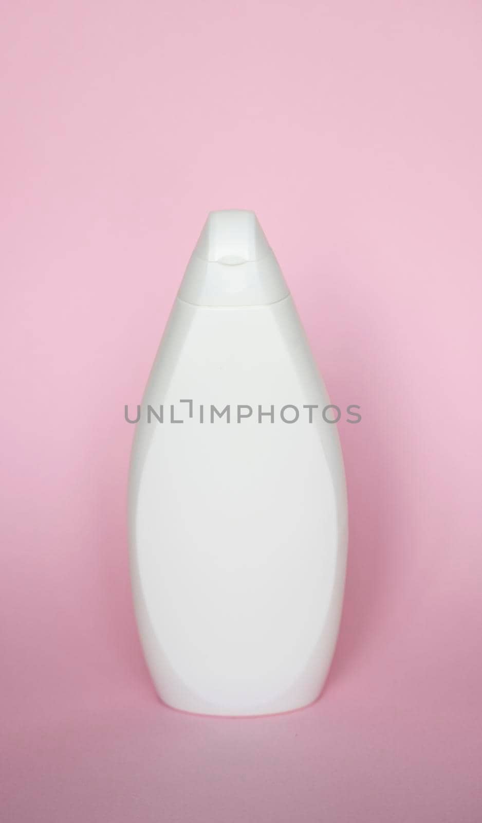 White plastic soap shampoo bottle isolated on pink background. Skin care lotion. Bathing essential product. Shampoo bottle. Bath and body lotion. Fine liquid hand wash. Bathroom accessories. by vovsht