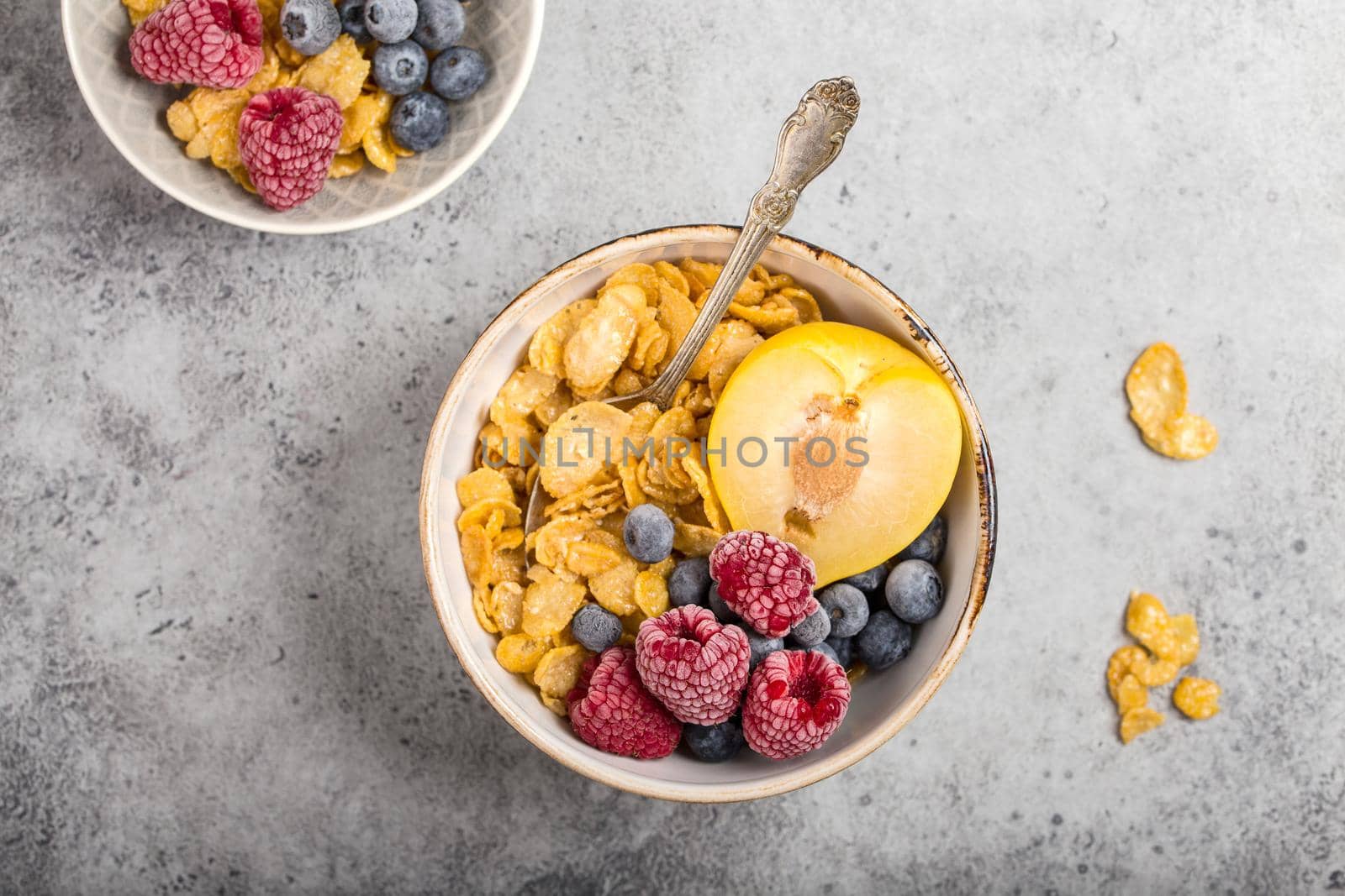 Healthy breakfast bowl, cereals, fresh fruit, berries on table. Clean eating, diet concept. Top view. Healthy bowl with cereals, raspberries, blueberries, plum. Granola. Vegetarian. Selective focus.