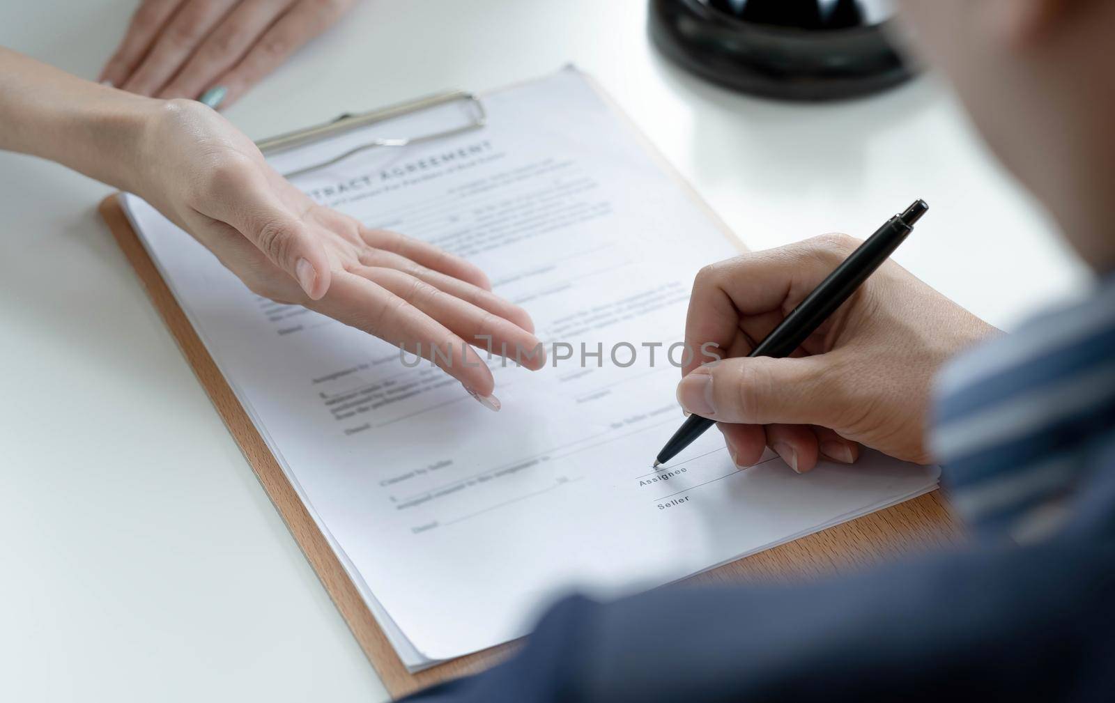 The hard work of an asian lawyer in a lawyer's office. Counseling and giving advice and prosecutions about the invasion of space between private and government officials to find a fair settlement..