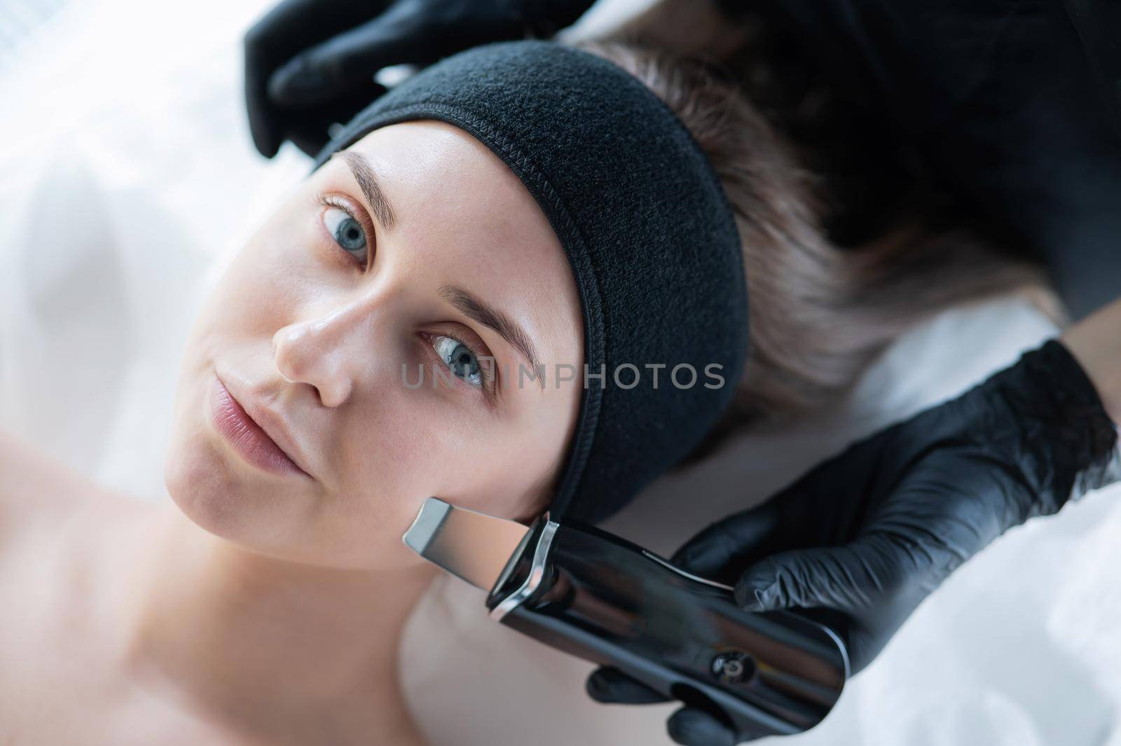 Top view of a woman on an ultrasonic cleaning procedure. Hardware cosmetology