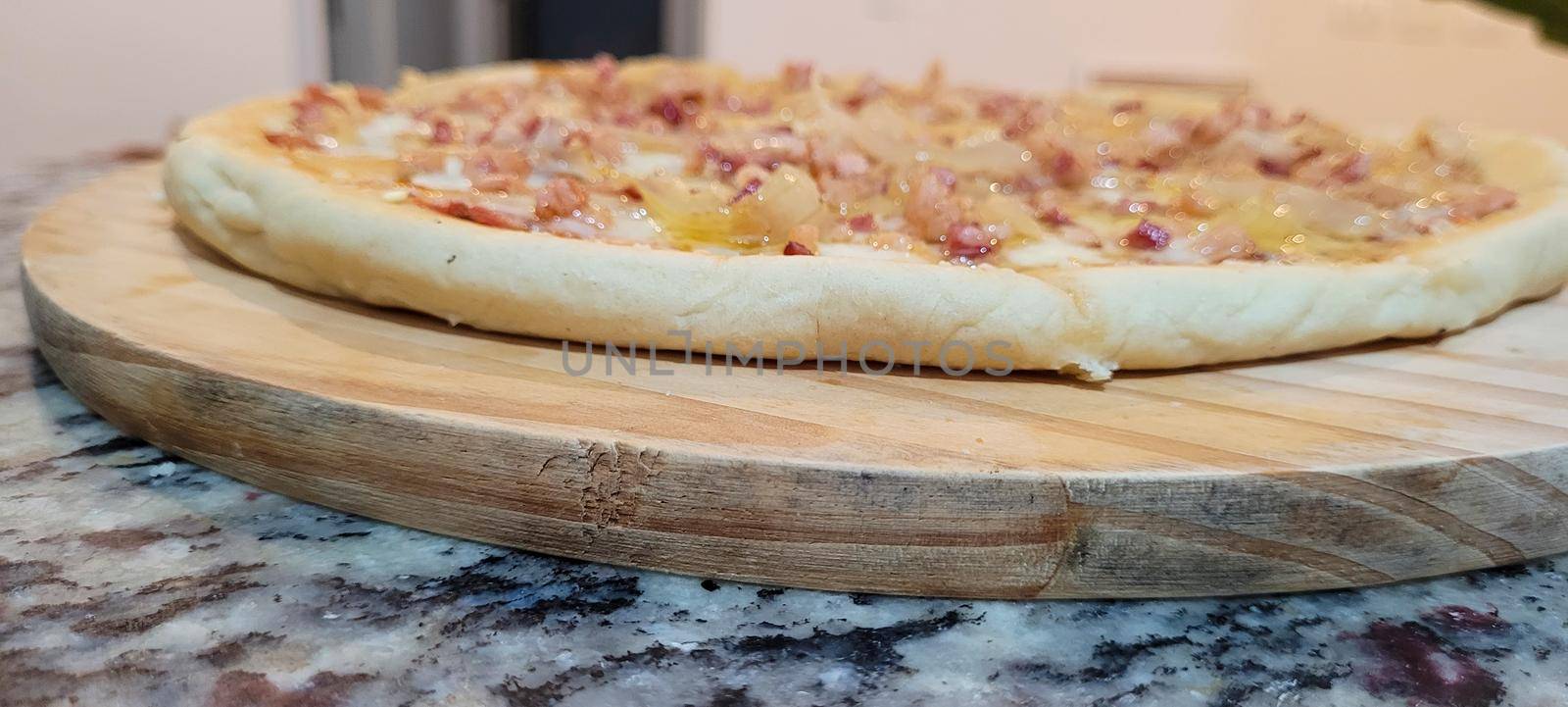 homemade homemade pizza with pasta made with a family recipe and stuffed with bacon, onion, cheese and sauce, great for a family weekend