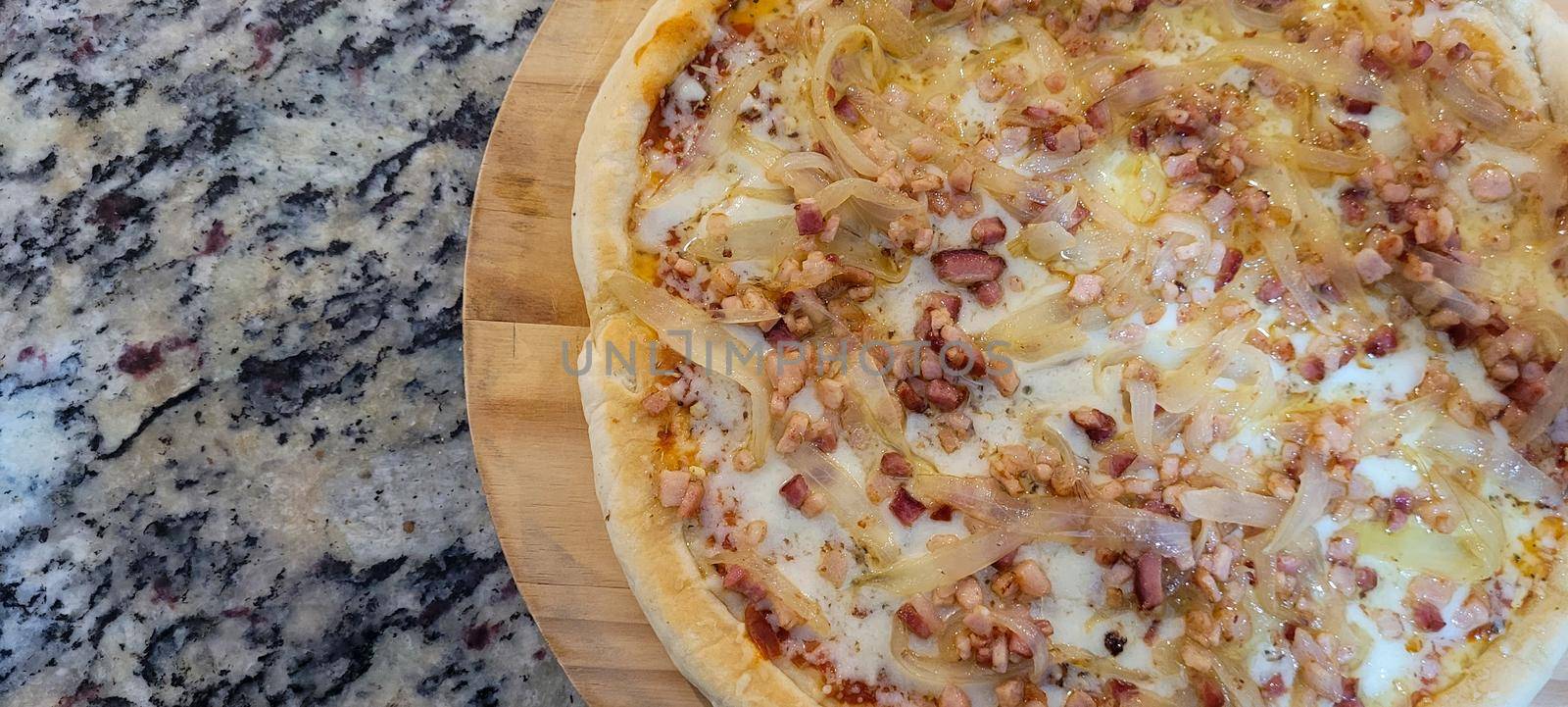 homemade homemade pizza with pasta made with a family recipe and stuffed with bacon, onion, cheese and sauce, great for a family weekend