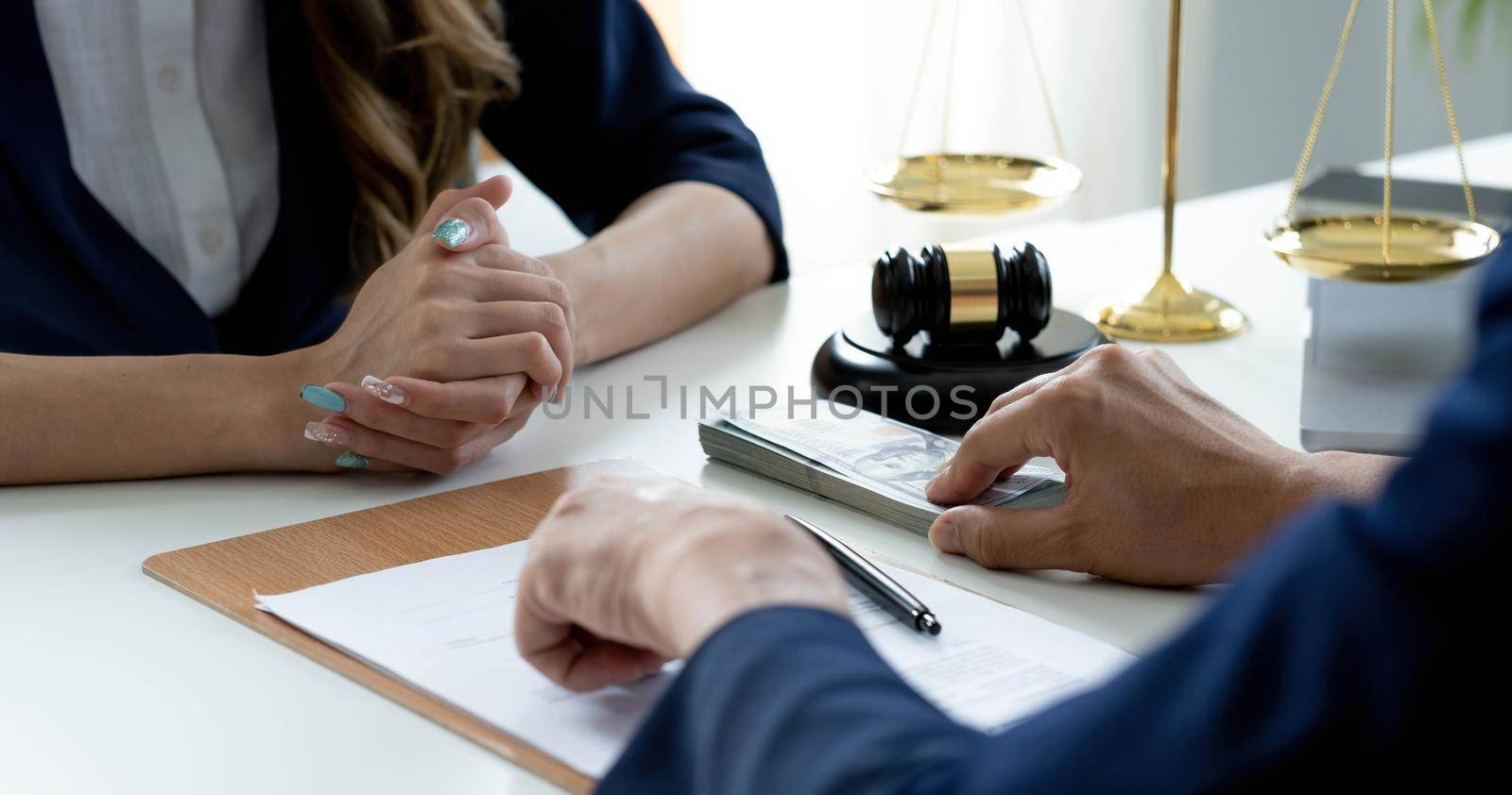 Close-up shot, A male client giving a house loan payment or mortgage fees to his female real estate agent. Property Investment concept by wichayada