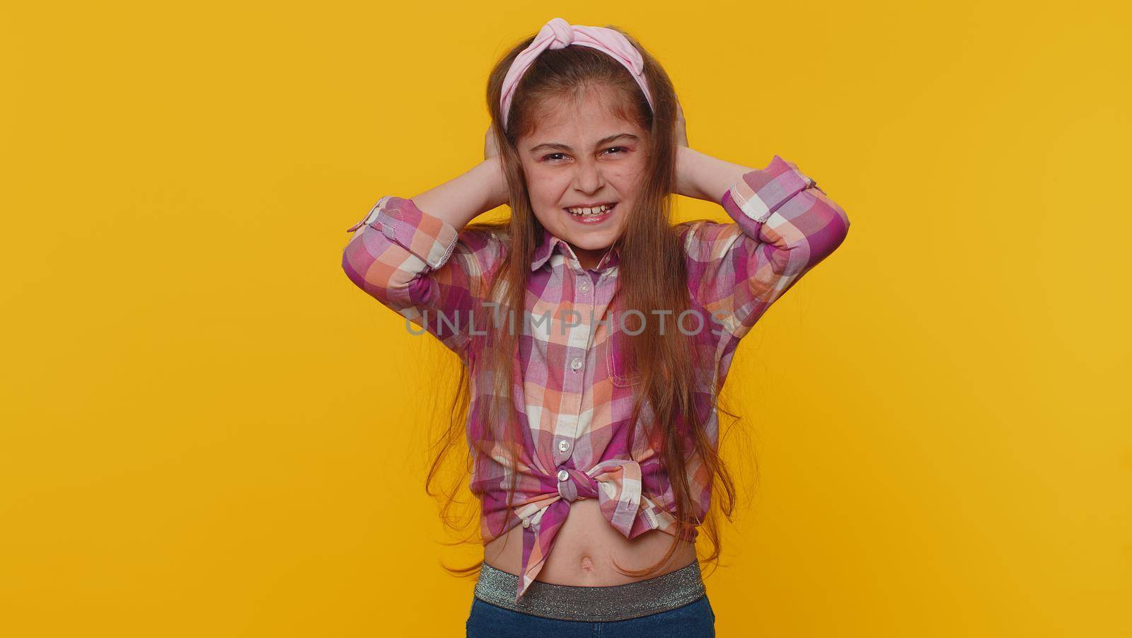 Dont want to hear and listen. Frustrated annoyed irritated young preteen child girl kid covering ears and gesturing no, avoiding advice ignoring unpleasant noise loud voices. Little toddler children
