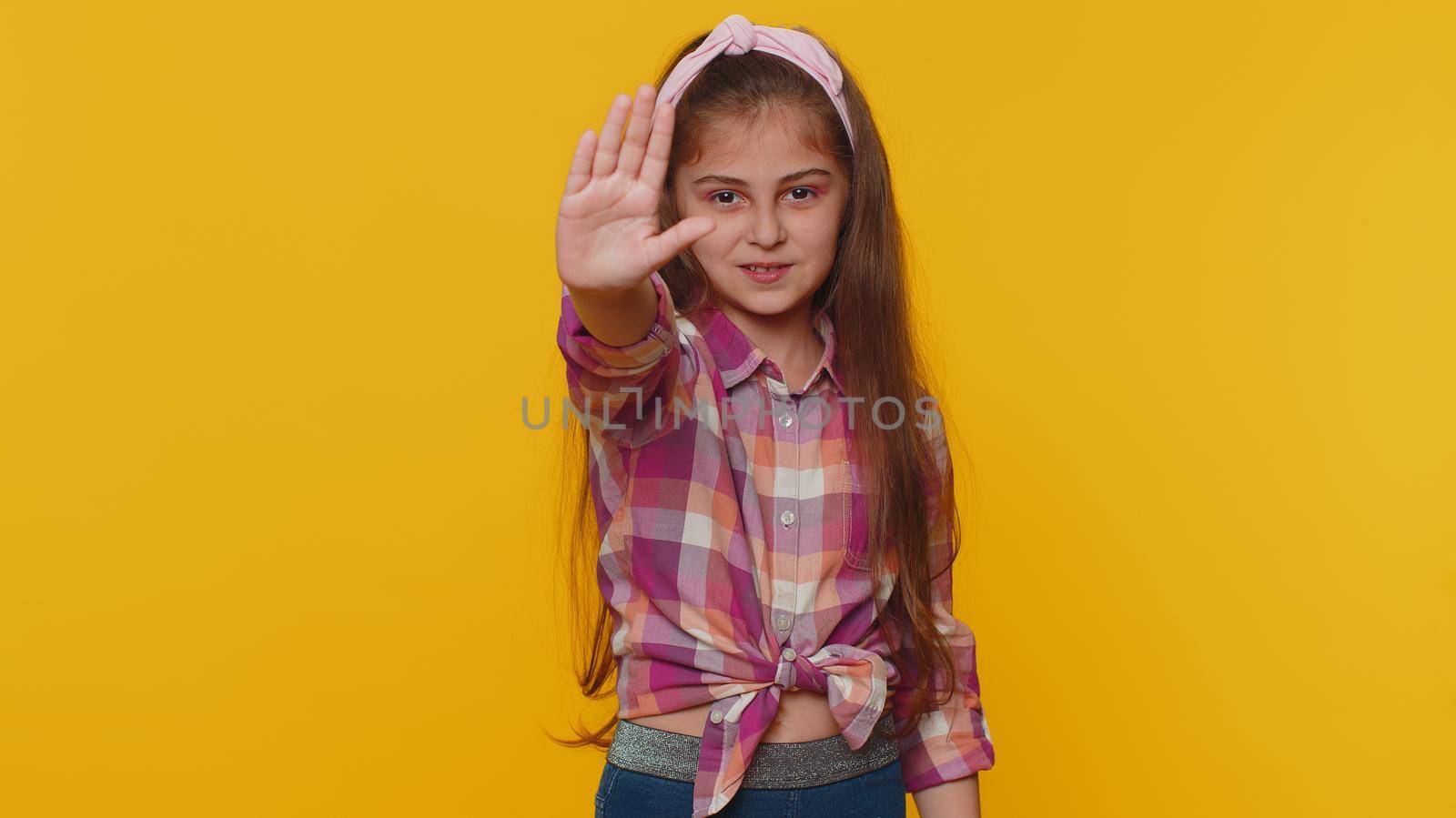 Stop gesture. Angry young preteen child girl kid say No hold palm folded crossed hands, warning of finish, prohibited access, declining communication, body language, danger. Little toddler children