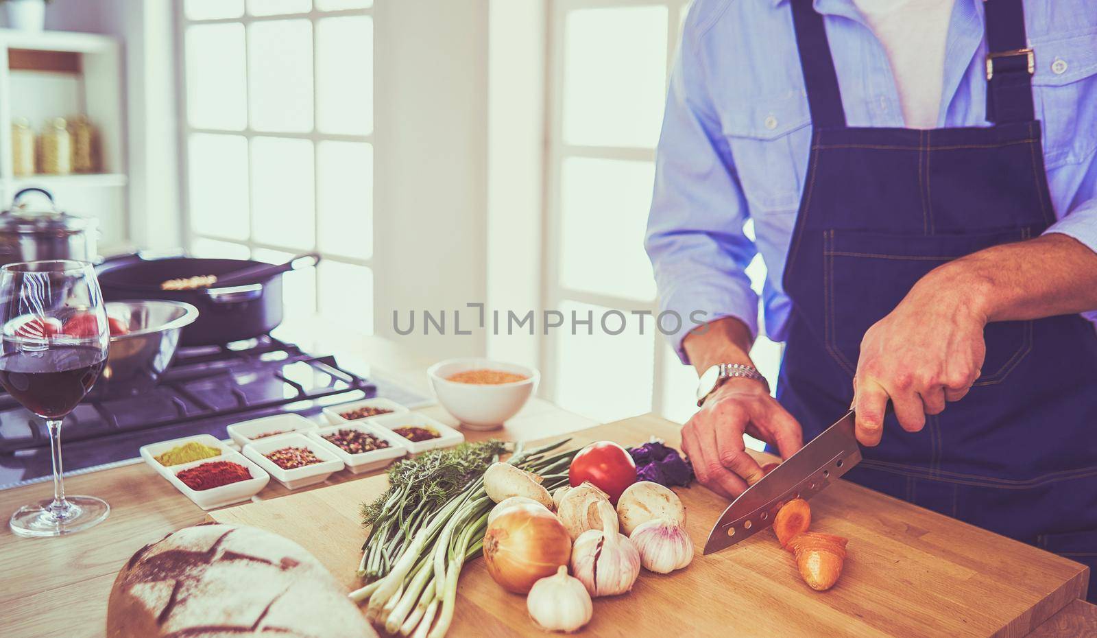 Man preparing delicious and healthy food in the home kitchen by lenets
