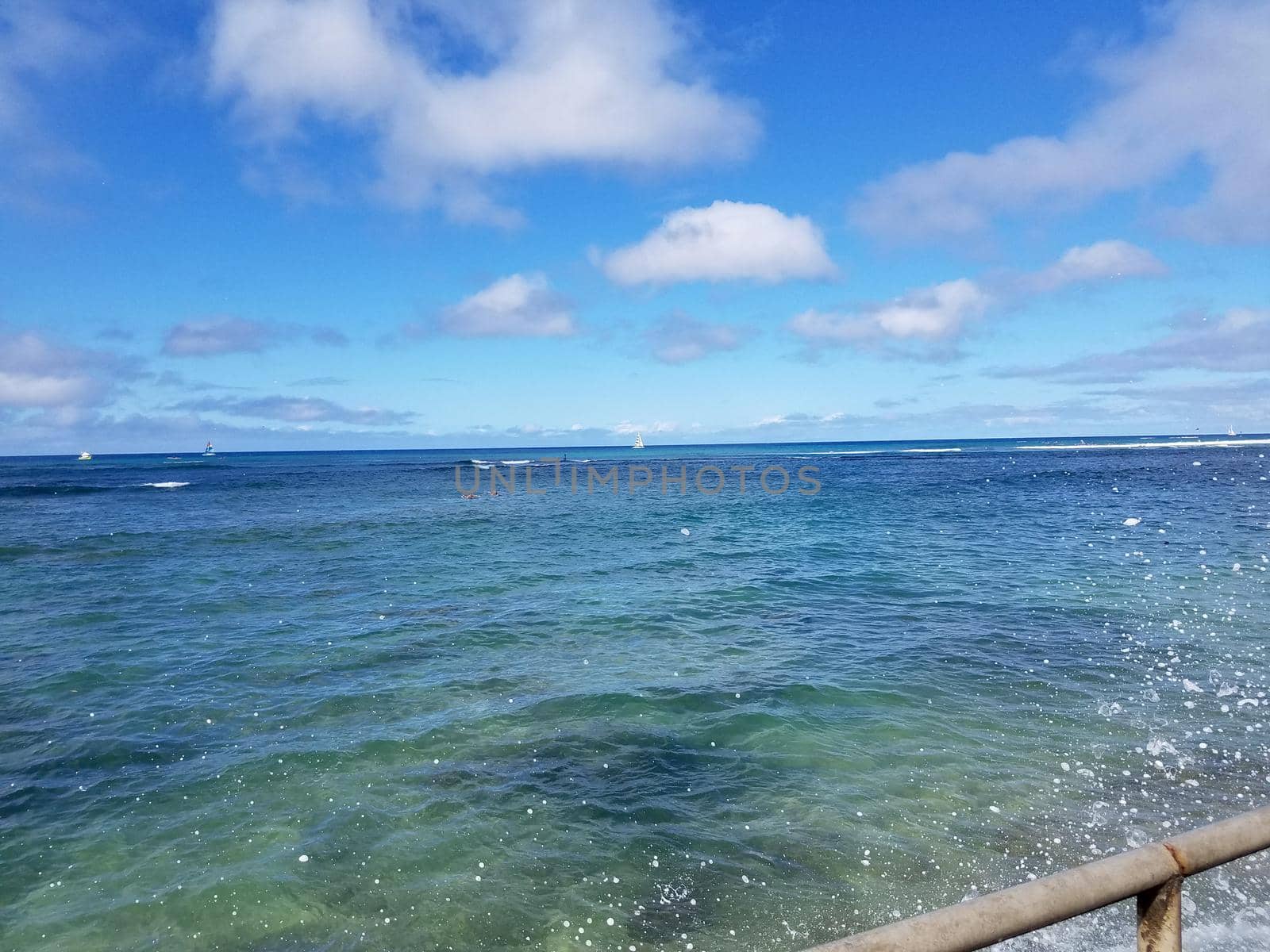 Shades of Turquoise Blue Ocean Water ripples off South Shore of Oahu with boats on ocean by EricGBVD