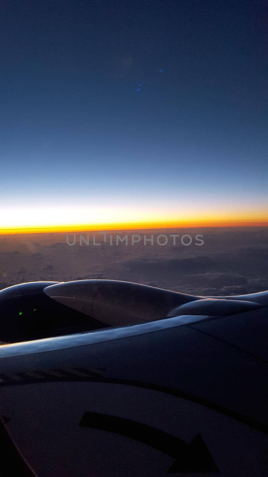 Sunrise light over the world full of clouds with Airplane Jet Wing.