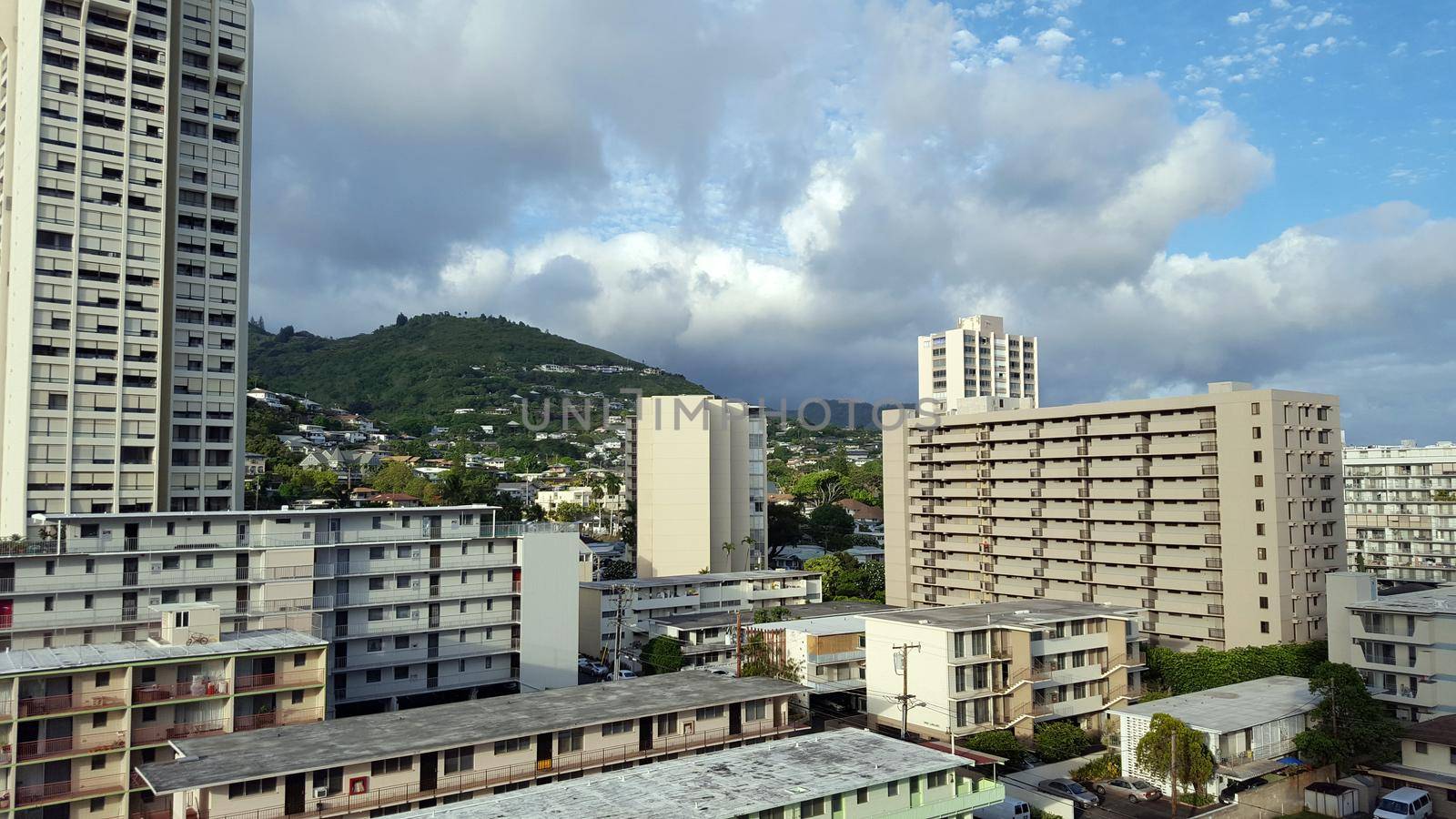 Makiki neighborhood, and Tantalus Mountain with houses and modern highrises, and other small buildings on a beautiful day on Oahu, Hawaii June 2016.