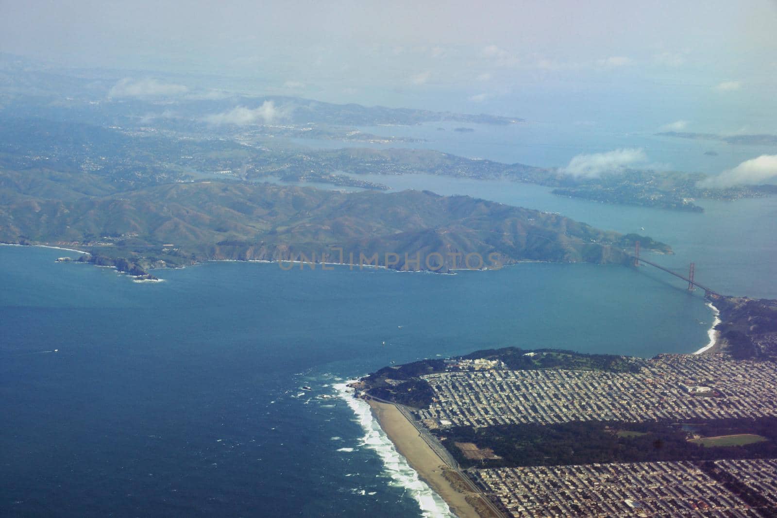 Golden Gate Bridge, Ocean Beach and the Sunset District of San Francisco and Marin County seen from the Air.