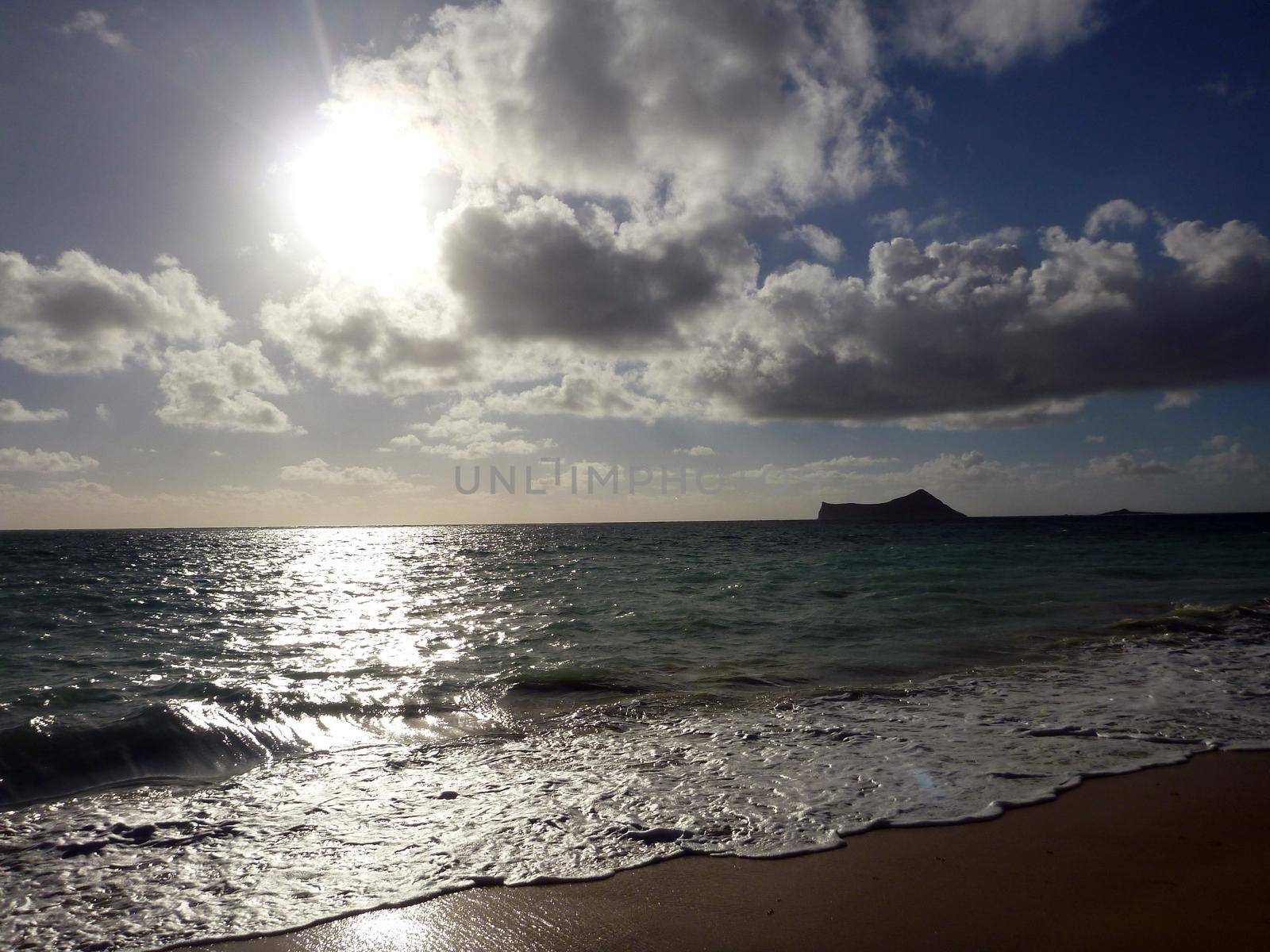 Early Morning Sunrise on Waimanalo Beach on Oahu, Hawaii bursting through the clouds. 2012.