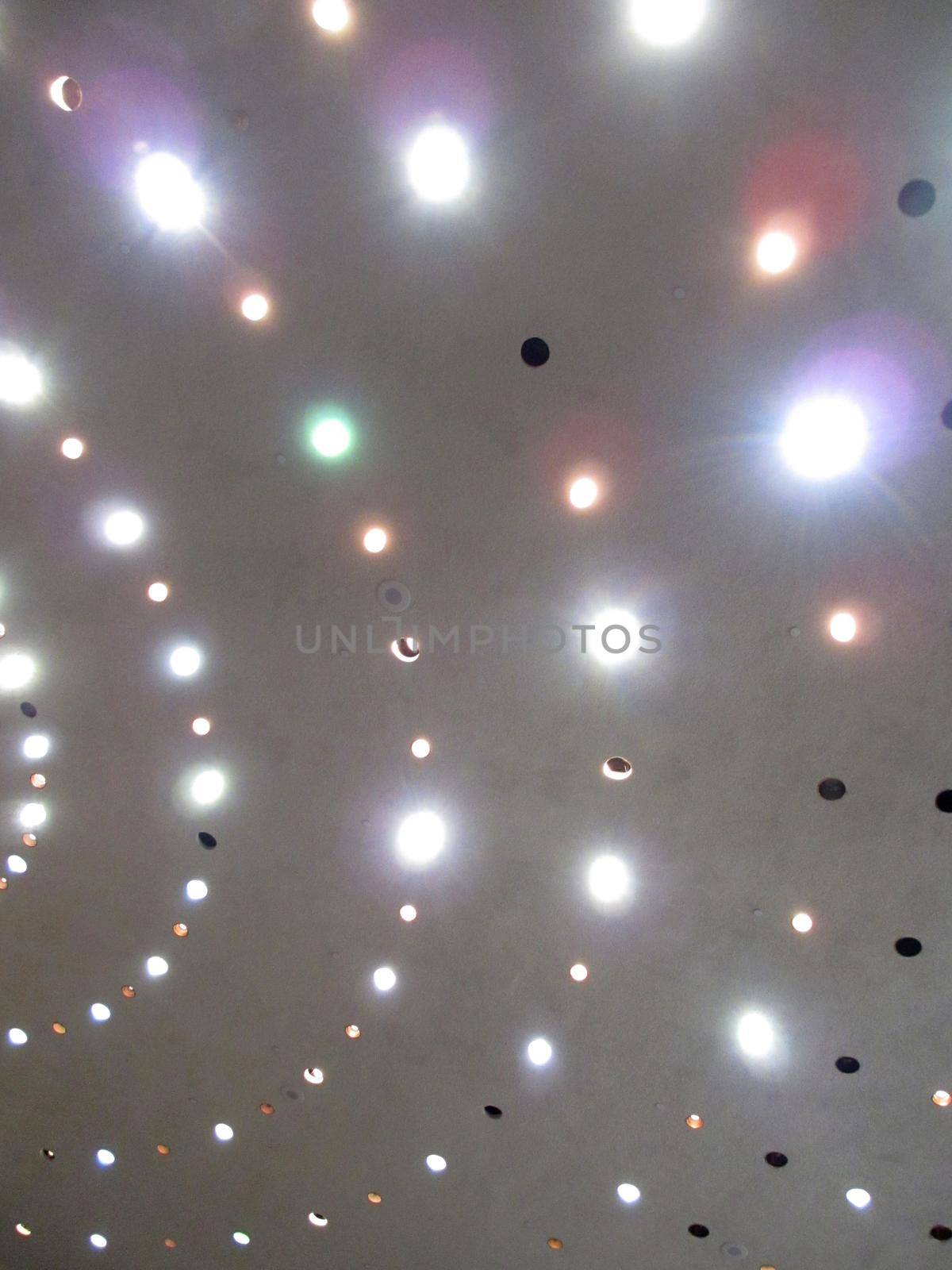 Circle Pattern of Overhead Lights on the ceiling of the roof of building.