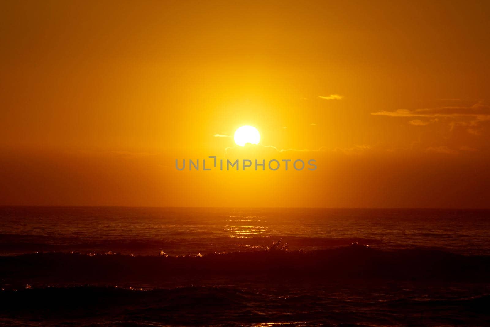 Sunrise over the ocean with waves crashing along shore by EricGBVD