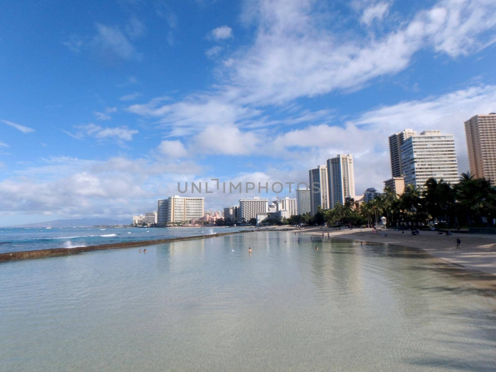 People play in the protected water and hang out on the Kuhio Beach by EricGBVD