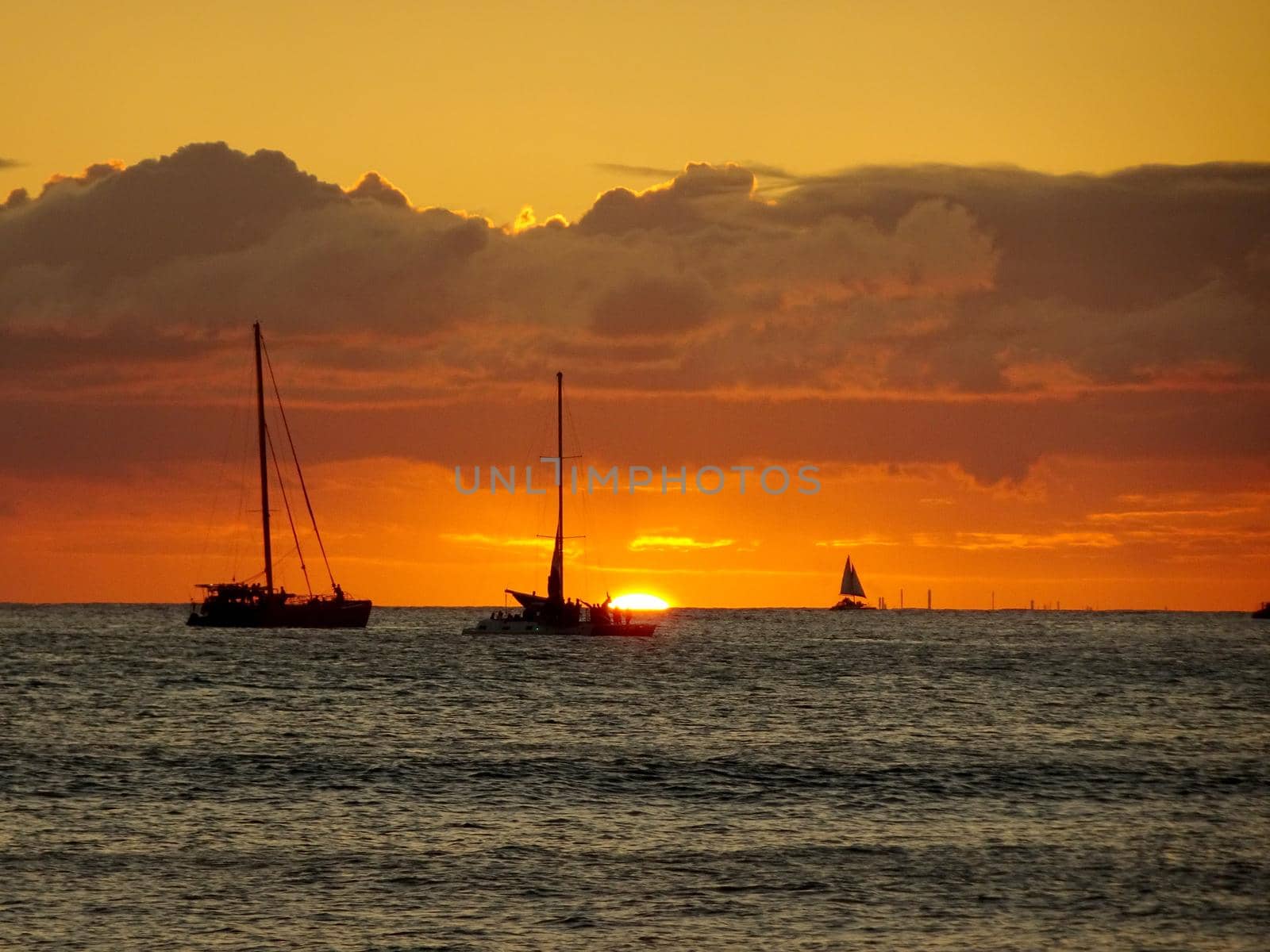 Boats on the pacific ocean waters of Waikiki at Sunset by EricGBVD