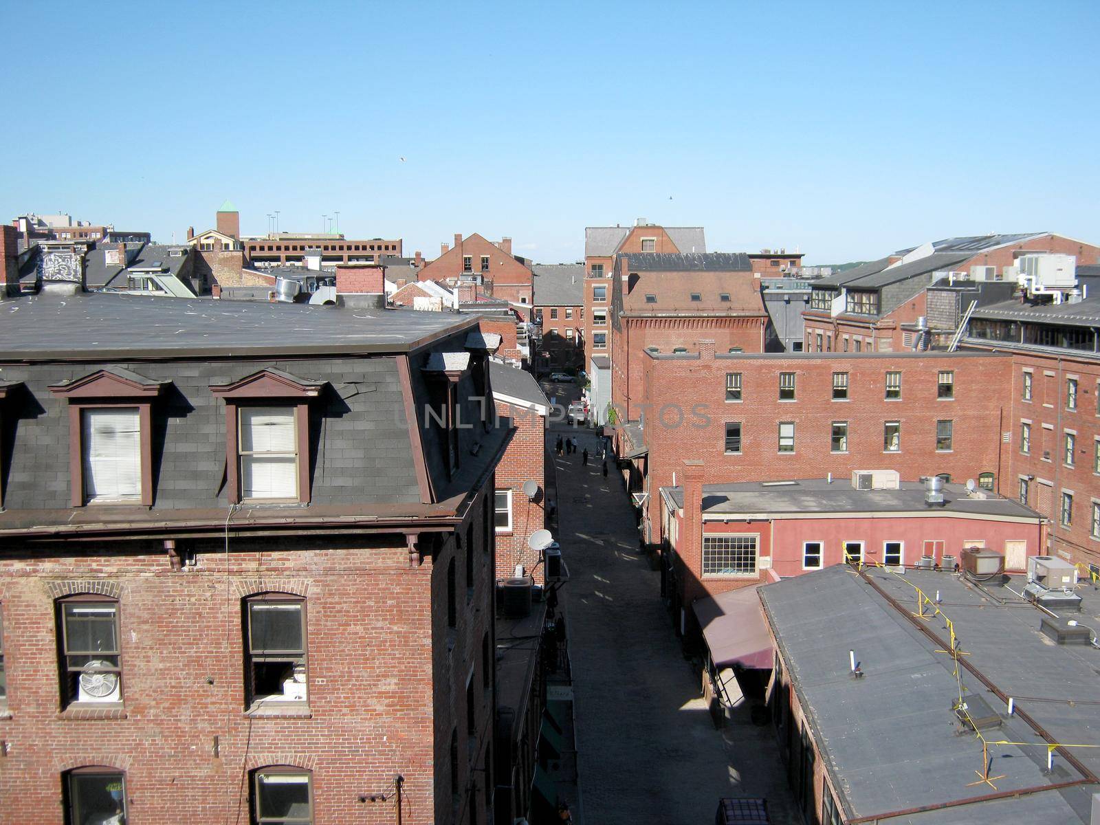 Portland, Maine cityscape aerial of Red Brick Buildings on Wharf Street from a top of building.