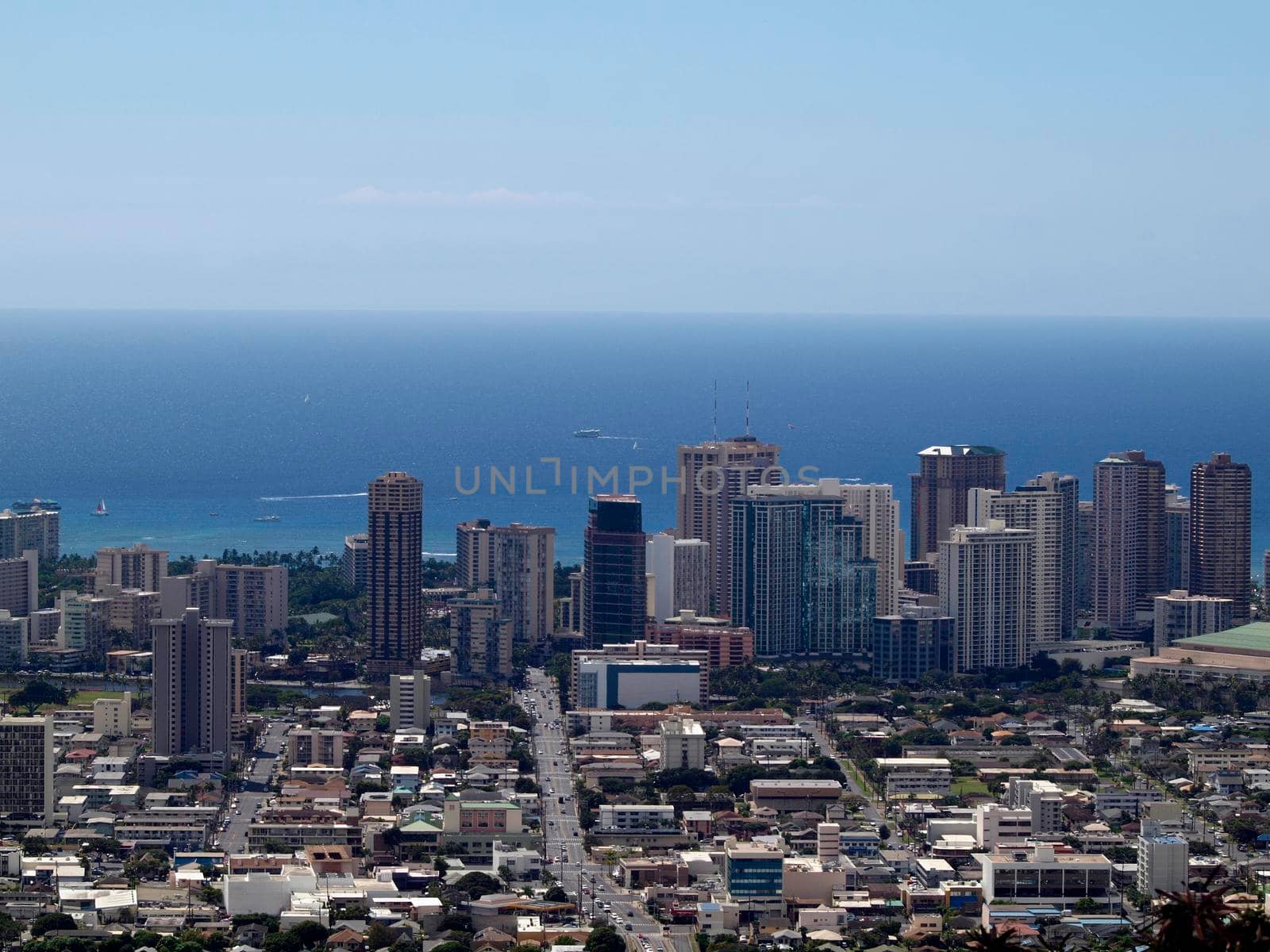 Honolulu - October 14, 2015:  Aerial of  Honolulu, Waikiki, Buildings, parks, hotels and Condos with Pacific Ocean and boats stretching into the distance on great day. 