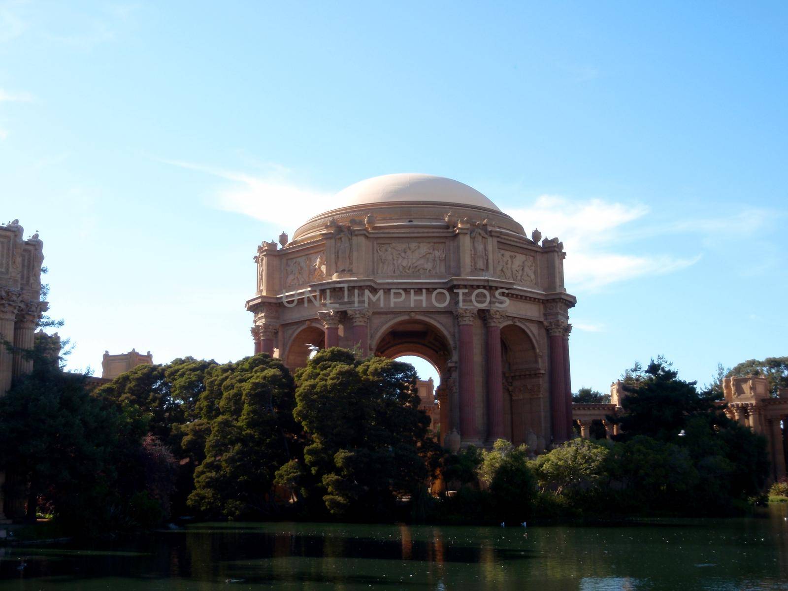 Palace of fine Arts dome and lake in San Francisco with a clear sky, s a monumental structure originally constructed for the 1915 Panama-Pacific Exposition in order to exhibit works of art presented there. One of only a few surviving structures from the Exposition, it is still situated on its original site. September 17, 2009.