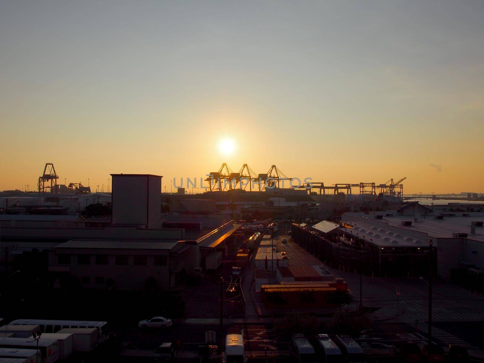 Aerial view of Sunset, Shipping Cranes, and Honolulu cityscape on Oahu, Hawaii January 12, 2016.  