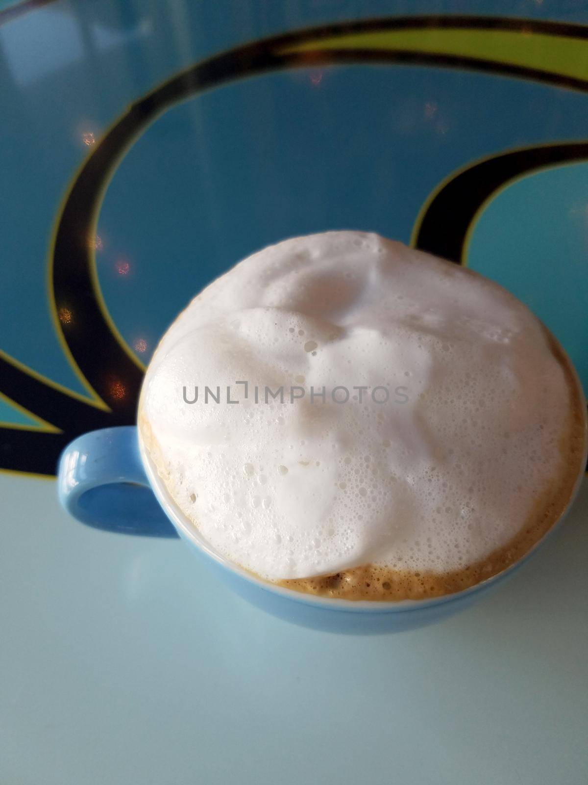 Blue cup of Cappuccino on saucer with large top of  foam by EricGBVD