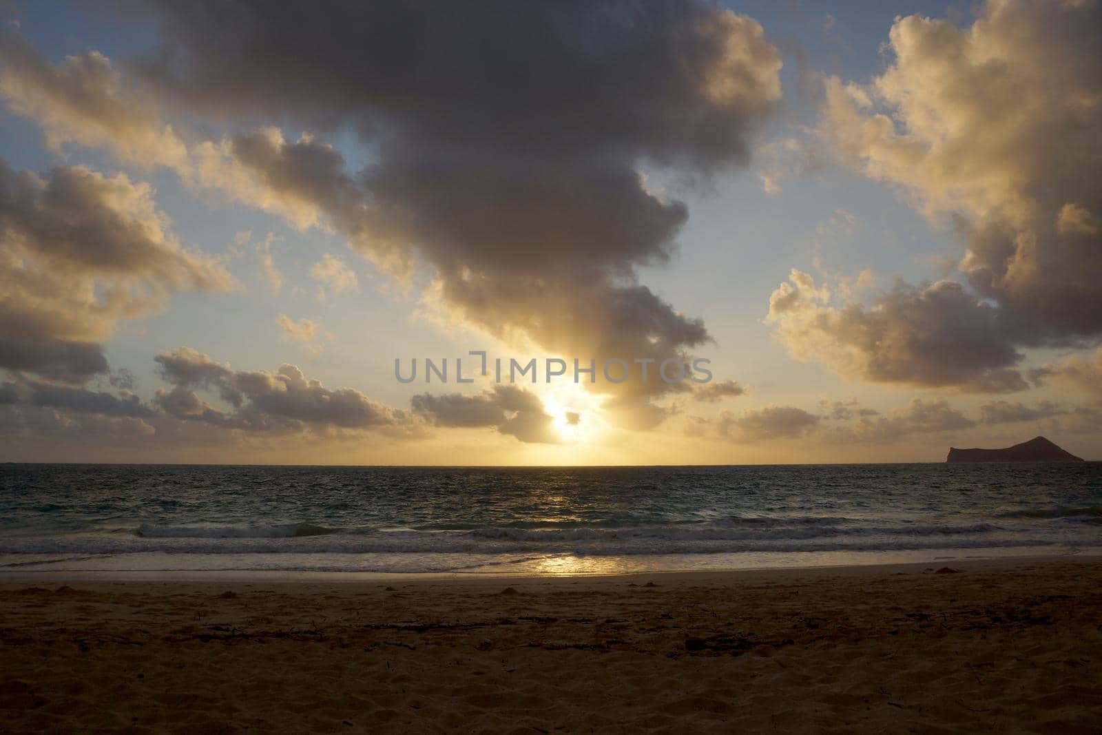 Early Morning Sunrise on Waimanalo Beach over Rock Island bursting through the clouds by EricGBVD