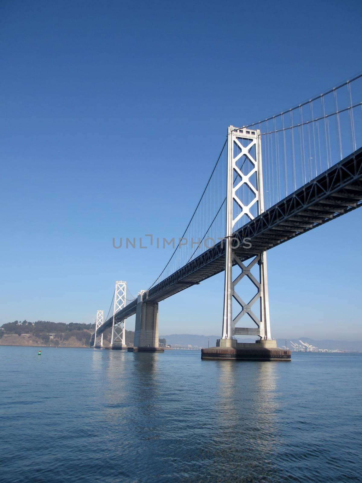 San Francisco side of Bay Bridge with Oakland in the distance on a clear day.