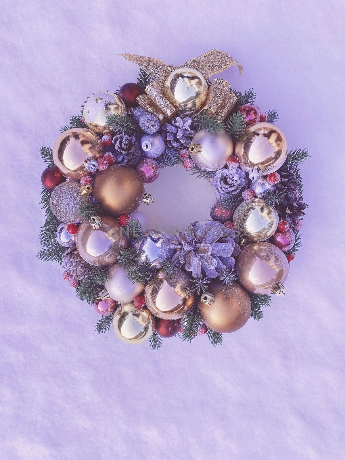 Christmas decorative wreath with pine cones, Christmas tree golden balls and ornaments on a textured background. Toned image in color Very Peri by Proxima13