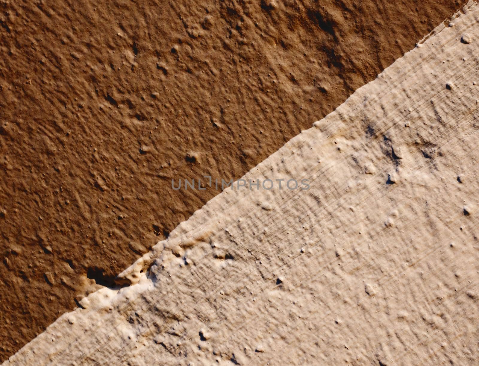 Abstract background of two color stucco diagonally.