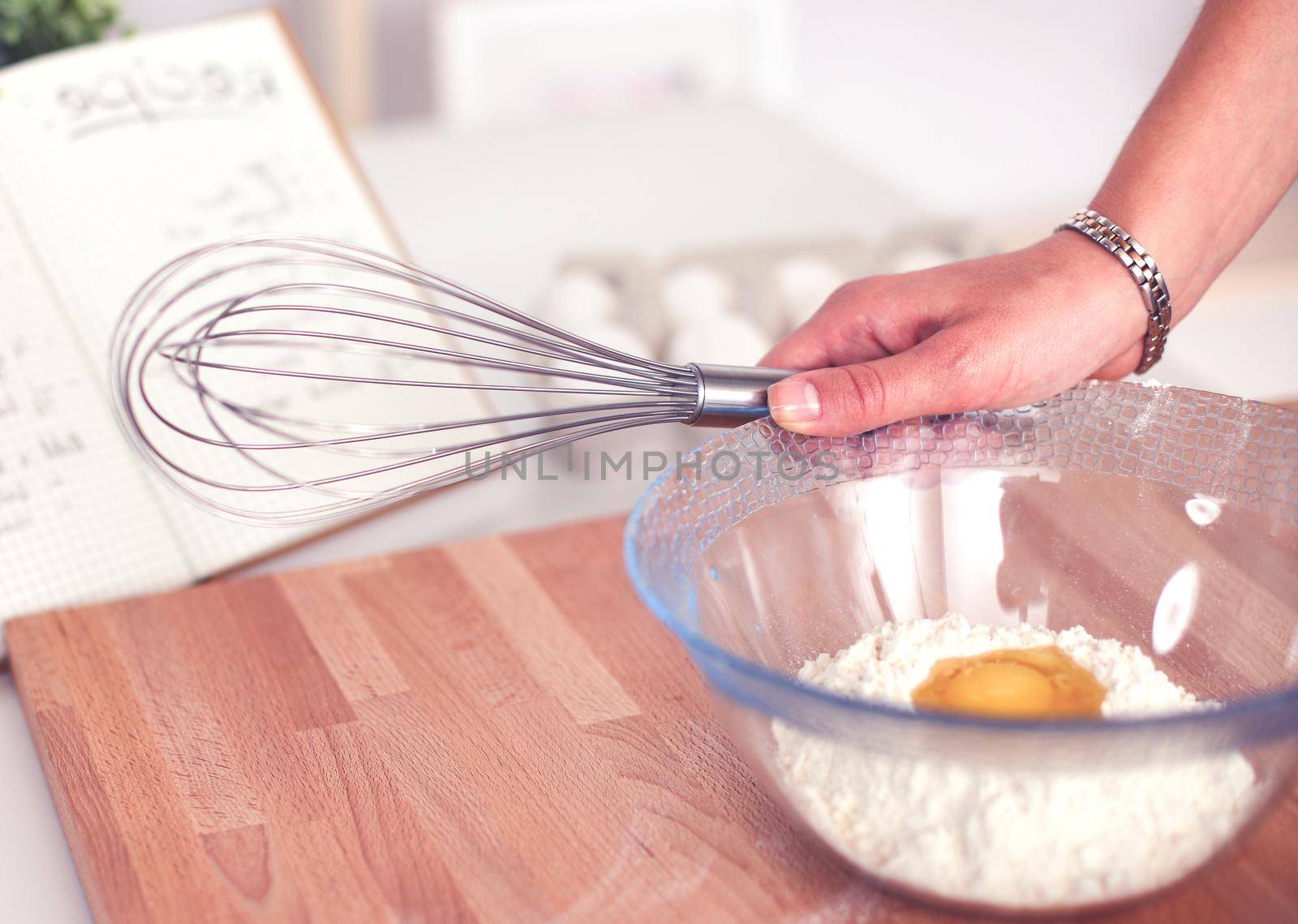 Woman is making cakes in the kitchen.