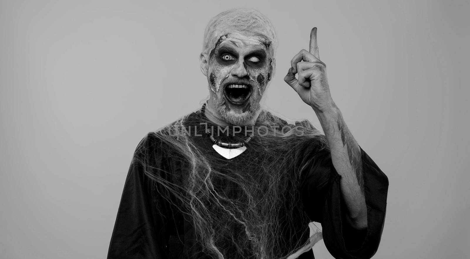Eureka. Inspired sinister man Halloween crazy zombie with bloody wounded scars face make gesture raises finger came up with creative plan feels excited with good idea, inspiration motivation. Horror