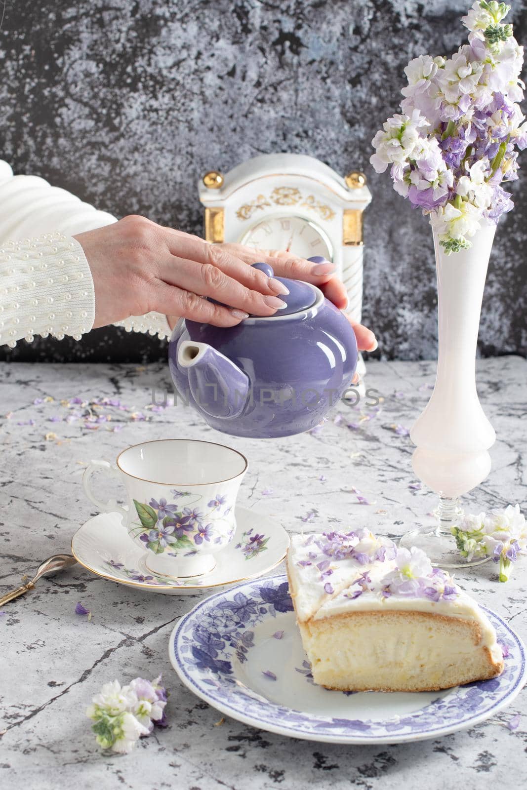 still life with black tea and cheese cake, spring bouquet of delicate lilac flowers. High quality photo